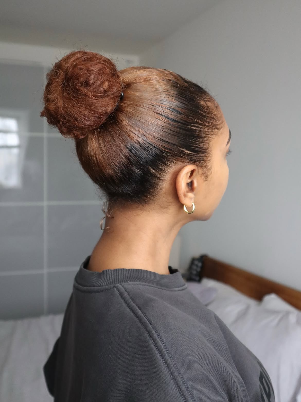 Glossy High Bun With Copper Balayage