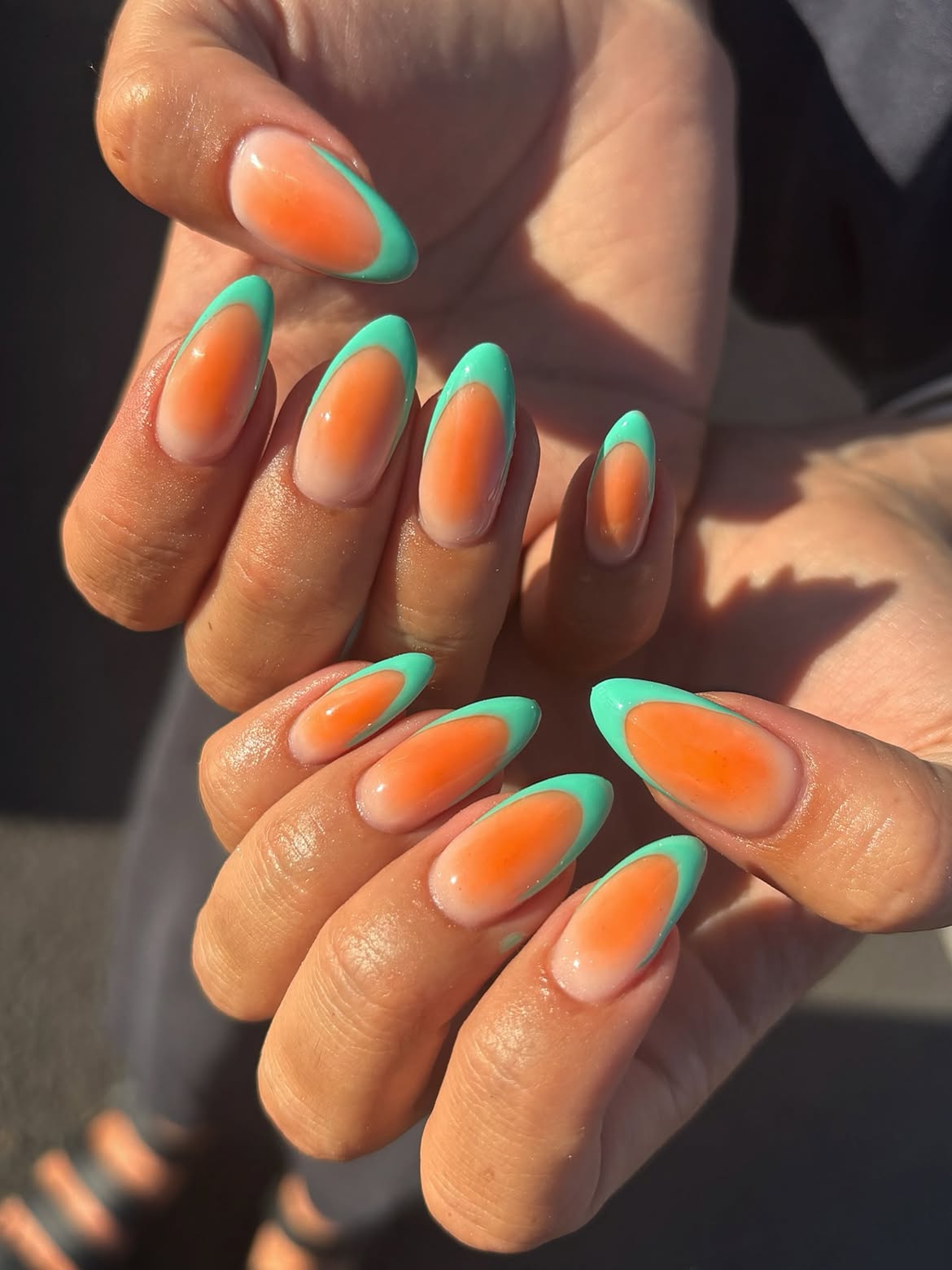Gradient Orange and Teal French Tip Almond Nails