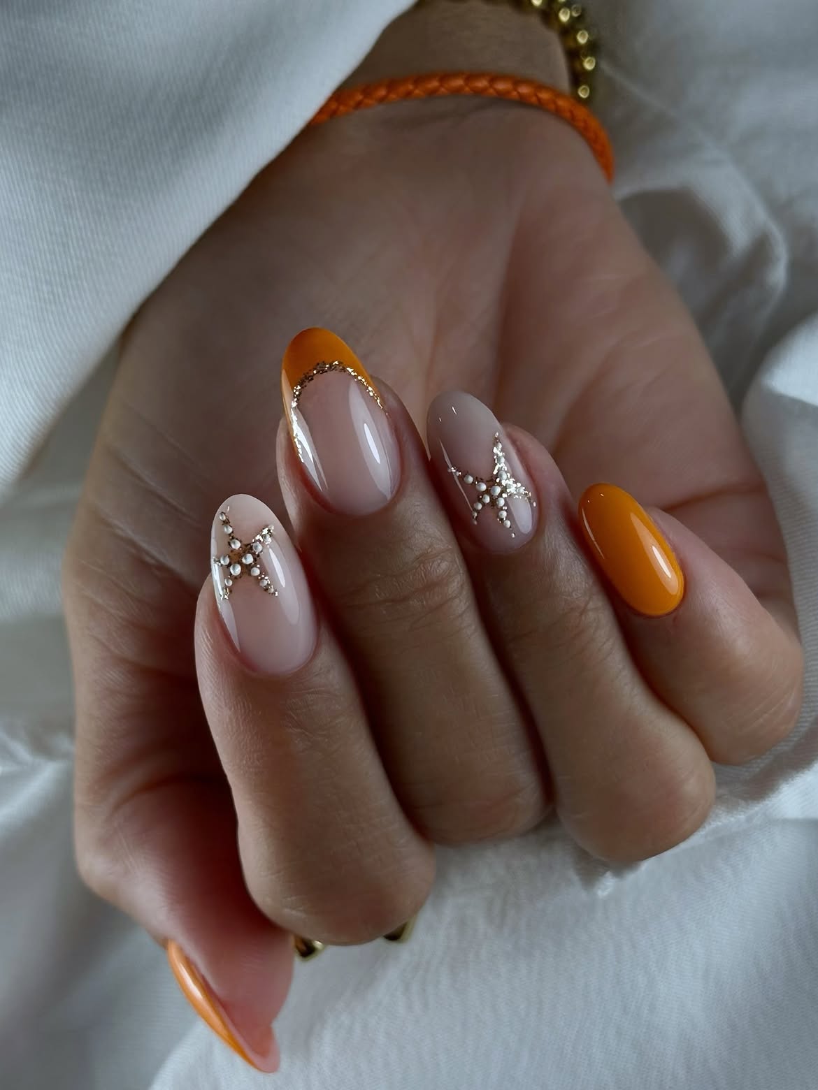 Orange French Tip Oval Nails with Star Embellishments