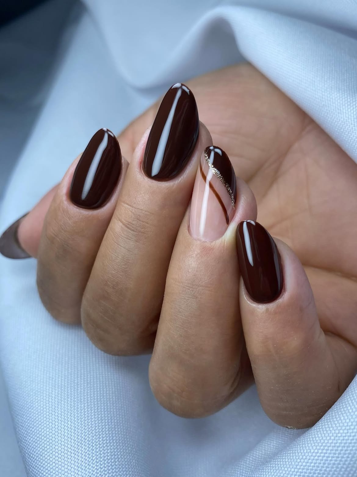 Rich Chocolate Almond Nails with Gold Stripe Accent