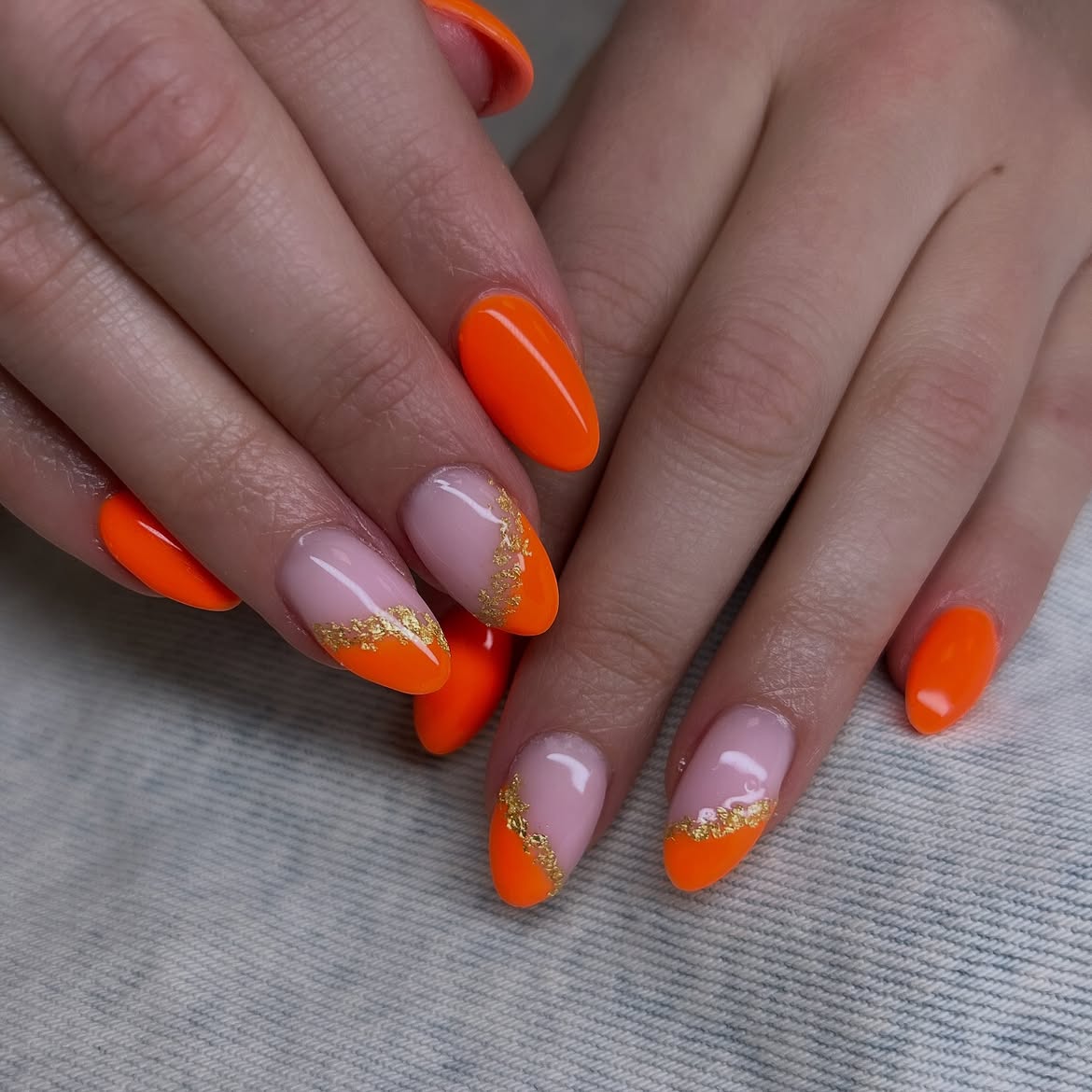 Vibrant Orange French Tips with Gold Flake Accents