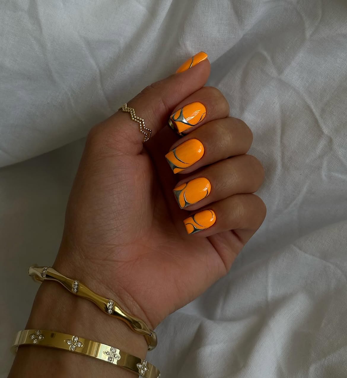 Vibrant Orange Marble Swirl Nails