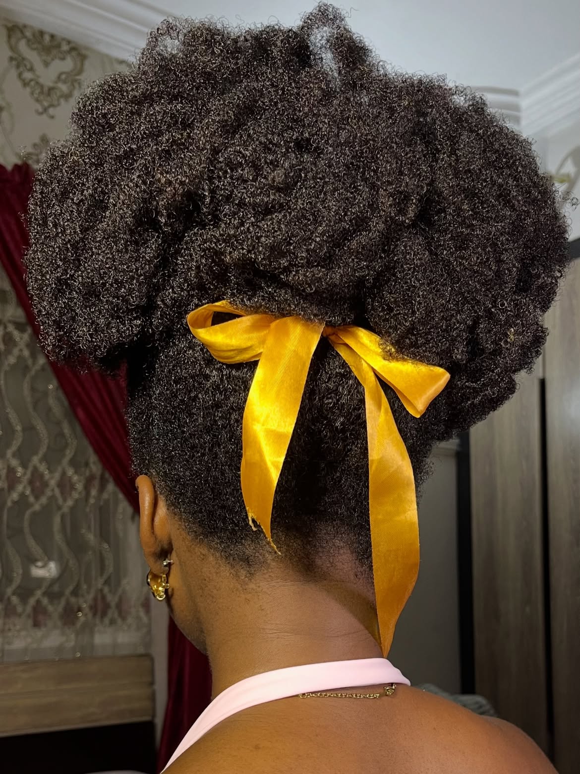 Voluminous Afro Puff With Golden Ribbon Accent