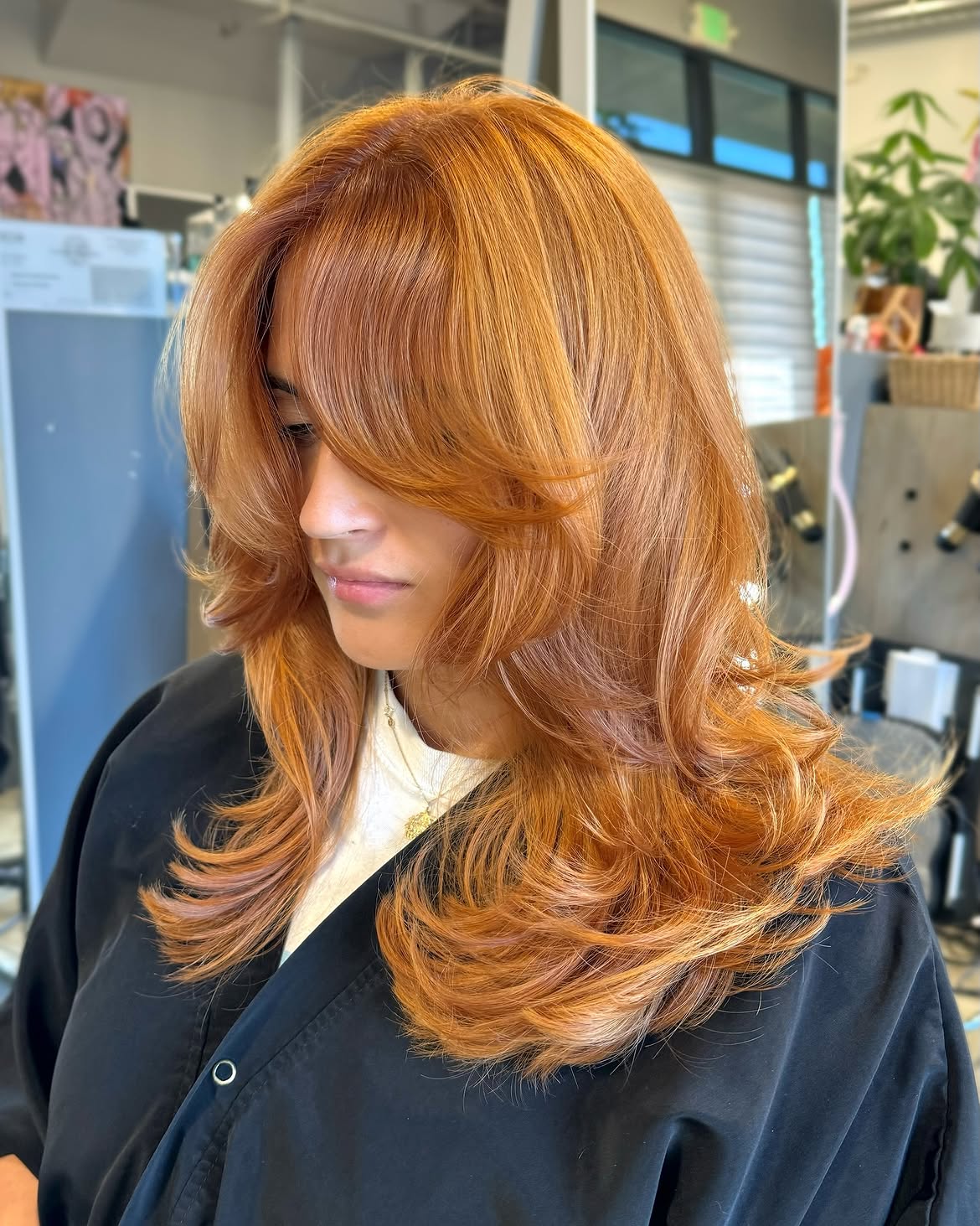 Warm Copper Layers With Face-Framing Curtain Bangs