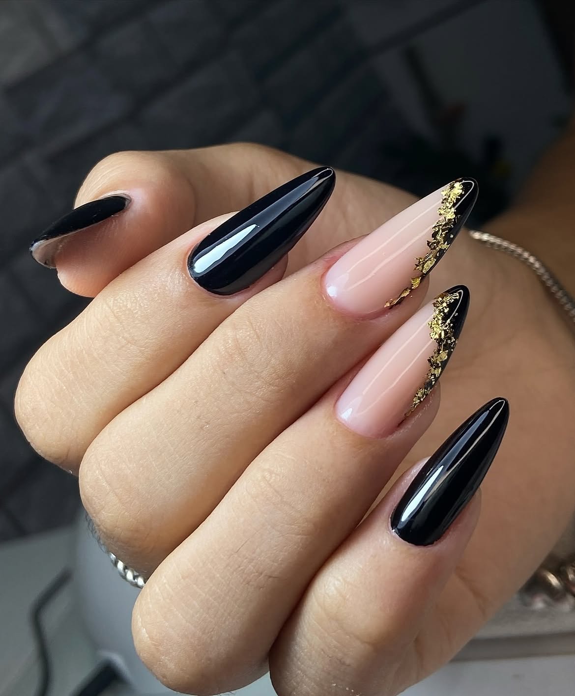 Black and Nude Almond Nails with Gold Flakes