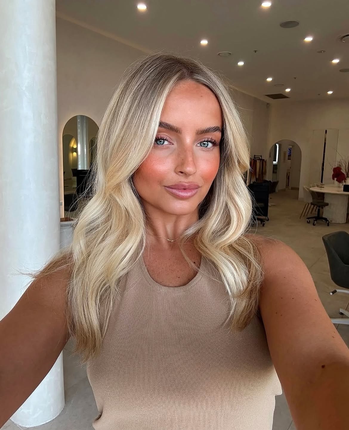 Bright Blonde Layers With Soft Curtain Bangs