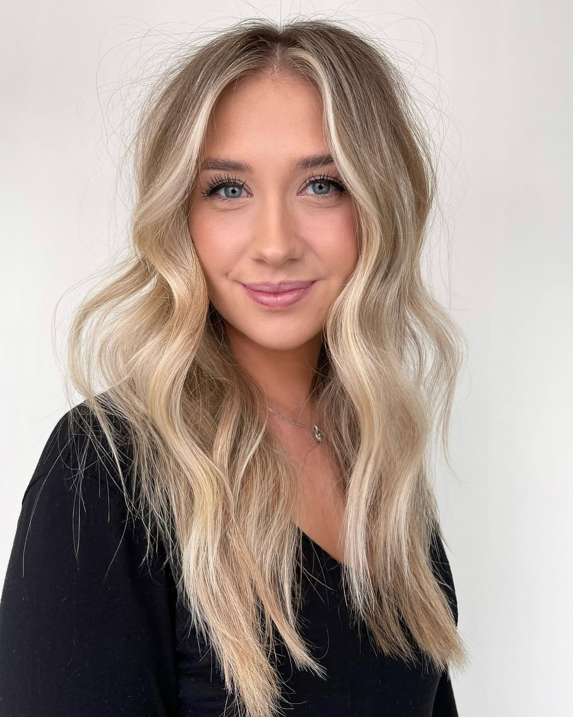 Bright Money Piece On Layered Sandy Blonde Waves