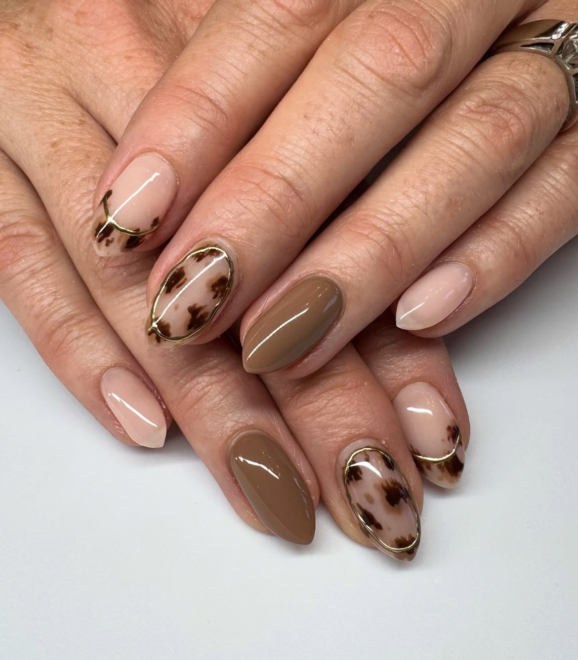 Brown Tortoiseshell Almond Nails With Gold Outline