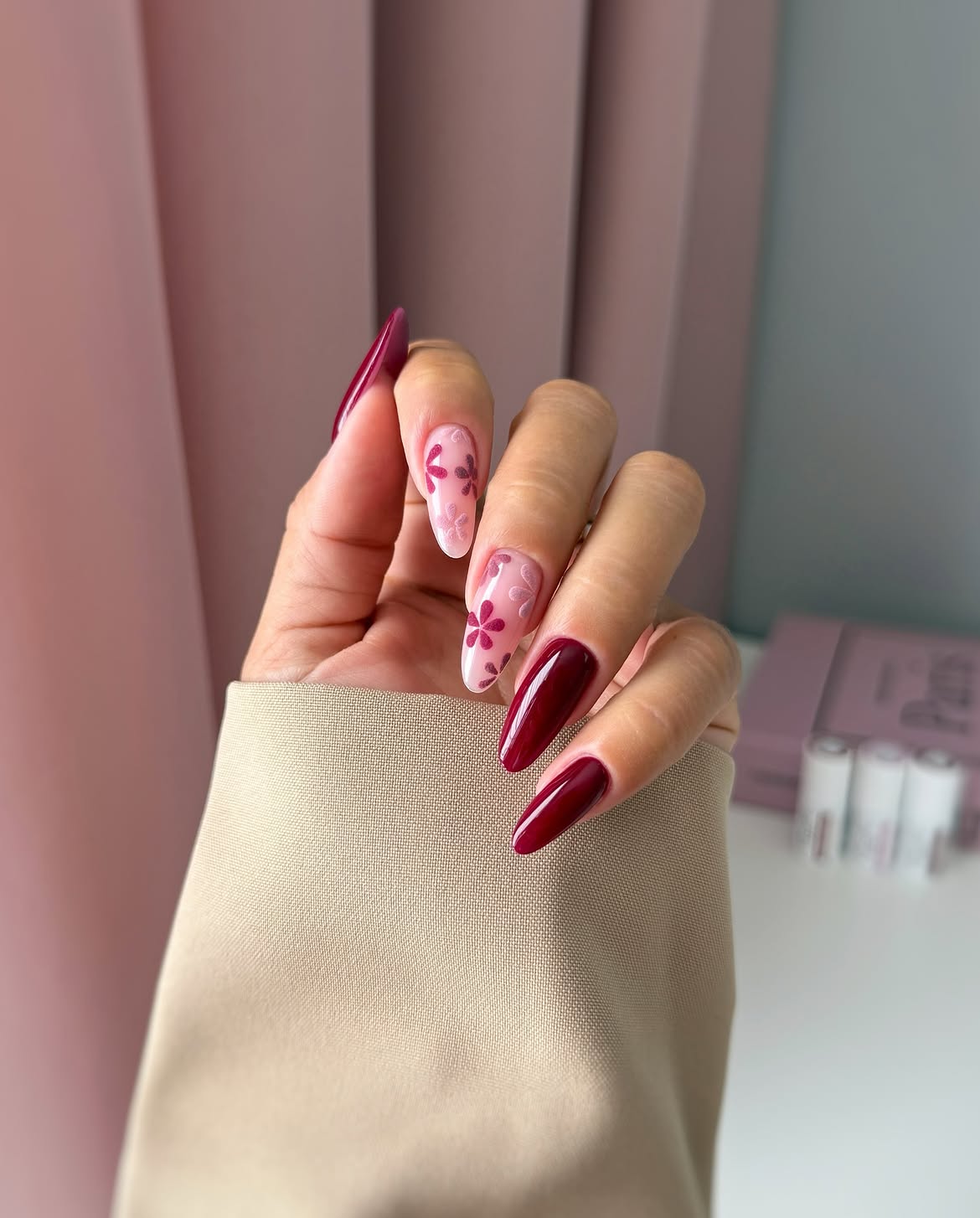 Burgundy Glossy Almond Nails with Pink Flower Accents