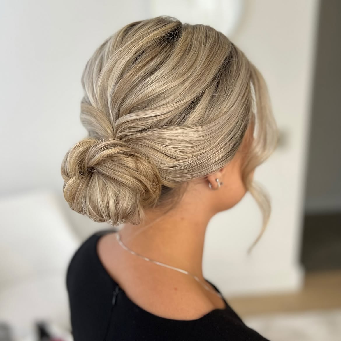 Chic Twisted Low Bun With Face-Framing Tendrils