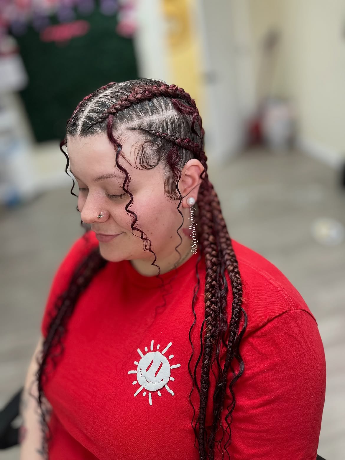 Deep Burgundy Cornrows With Curly Face Framing Tendrils
