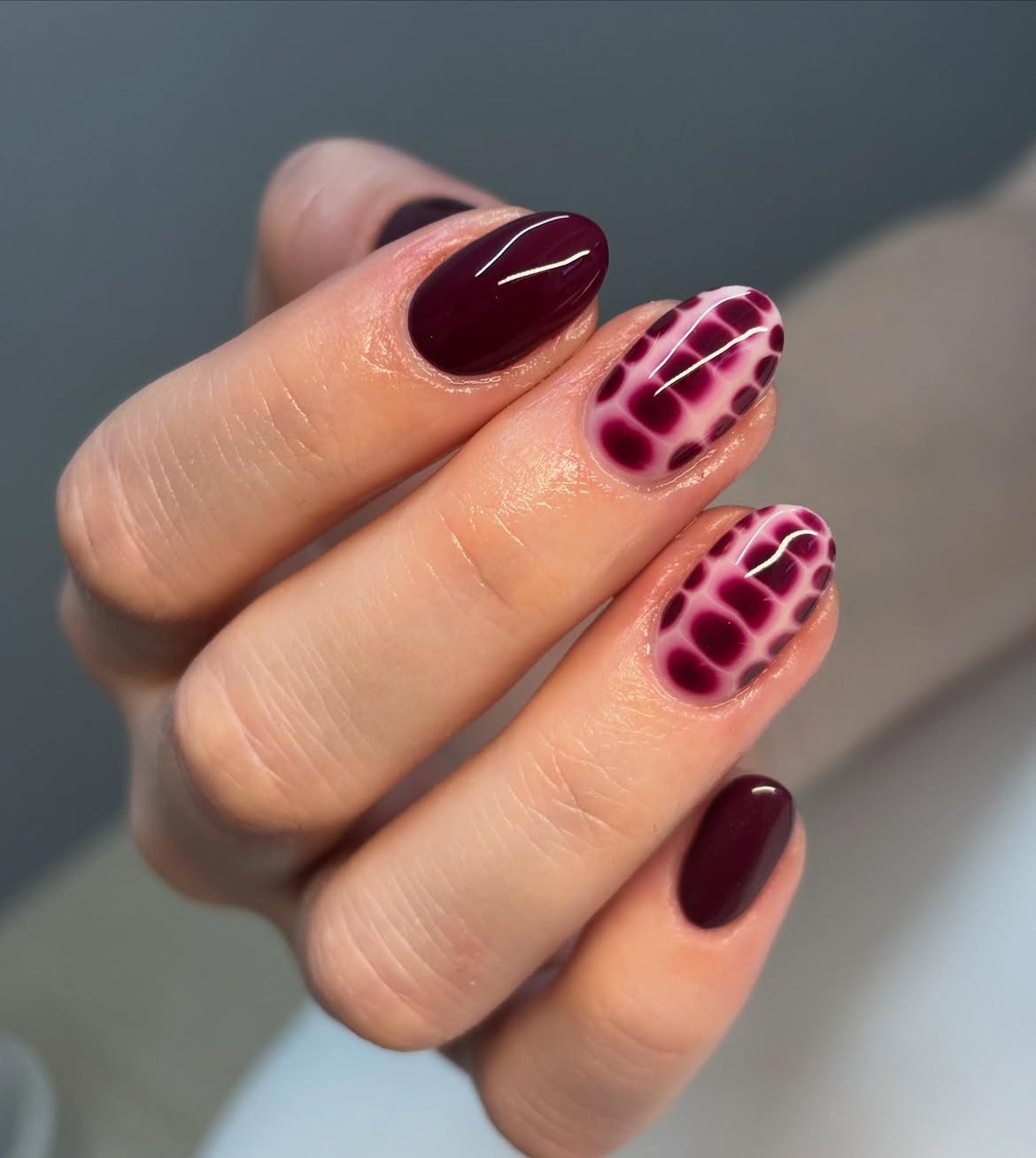 Deep Burgundy Glossy Oval Nails With Animal Print Accent