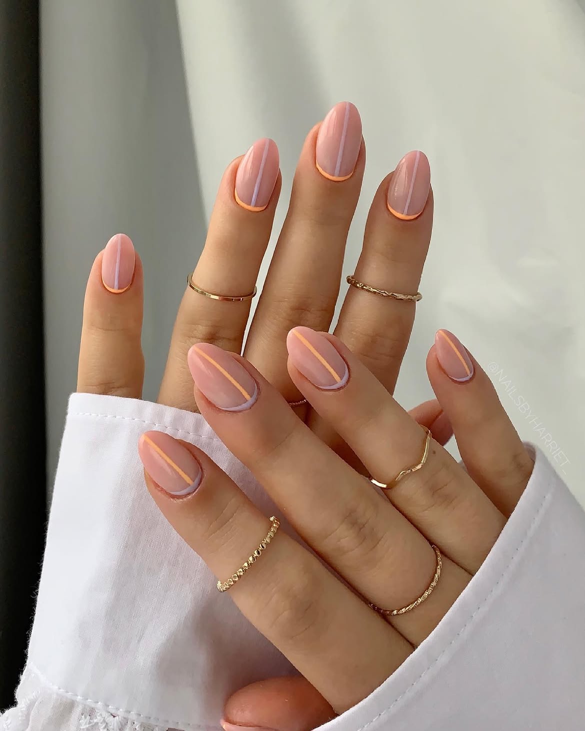 Delicate Striped Almond Nails with Peach and Lilac Accents