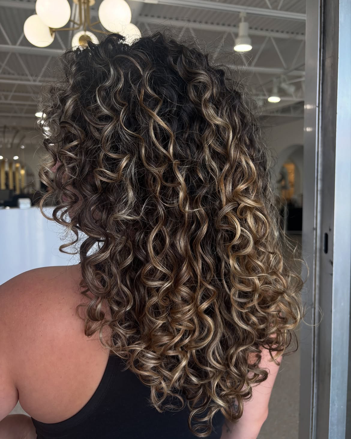 Dimensional Caramel Highlights On Long Curly Layers