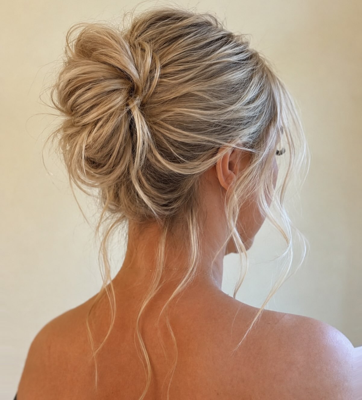 Effortless Chic Messy Bun With Face-Framing Tendrils