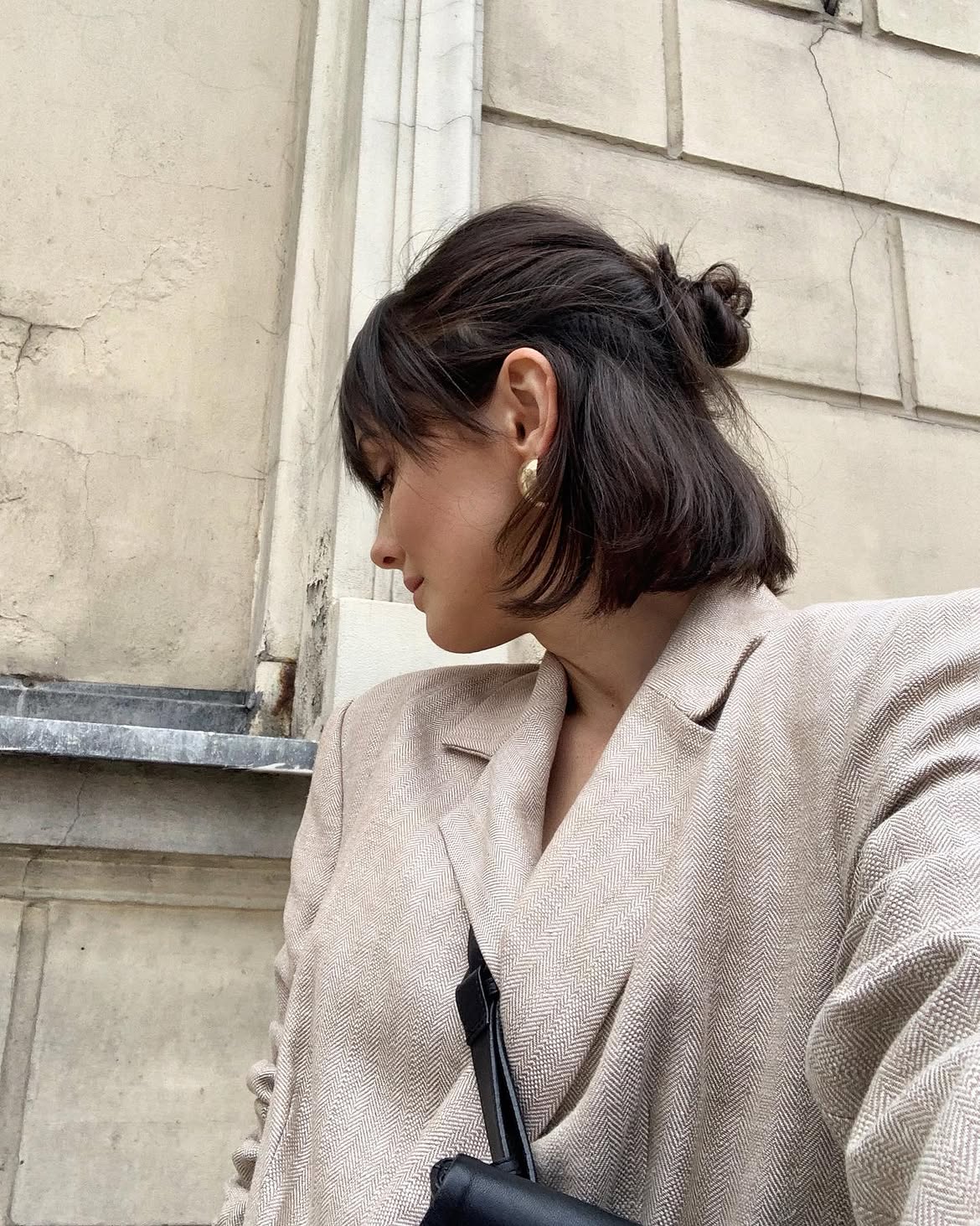 Effortless Chic Messy Top Knot With Curtain Bangs