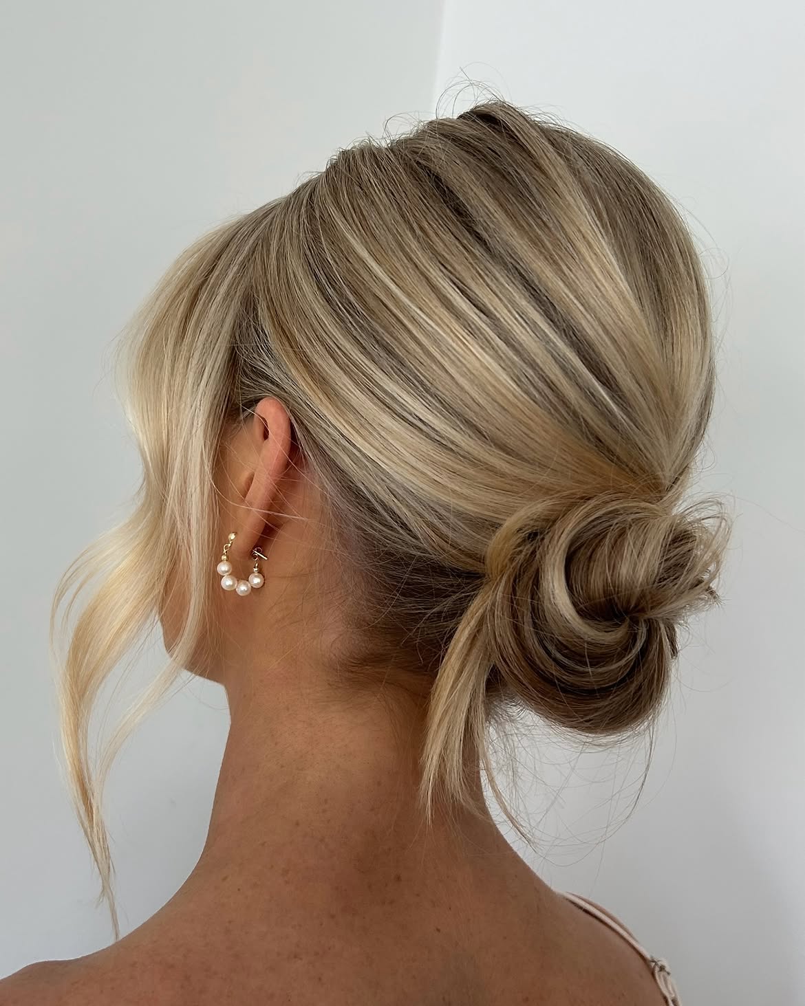 Effortless Low Chignon With Face-Framing Tendrils