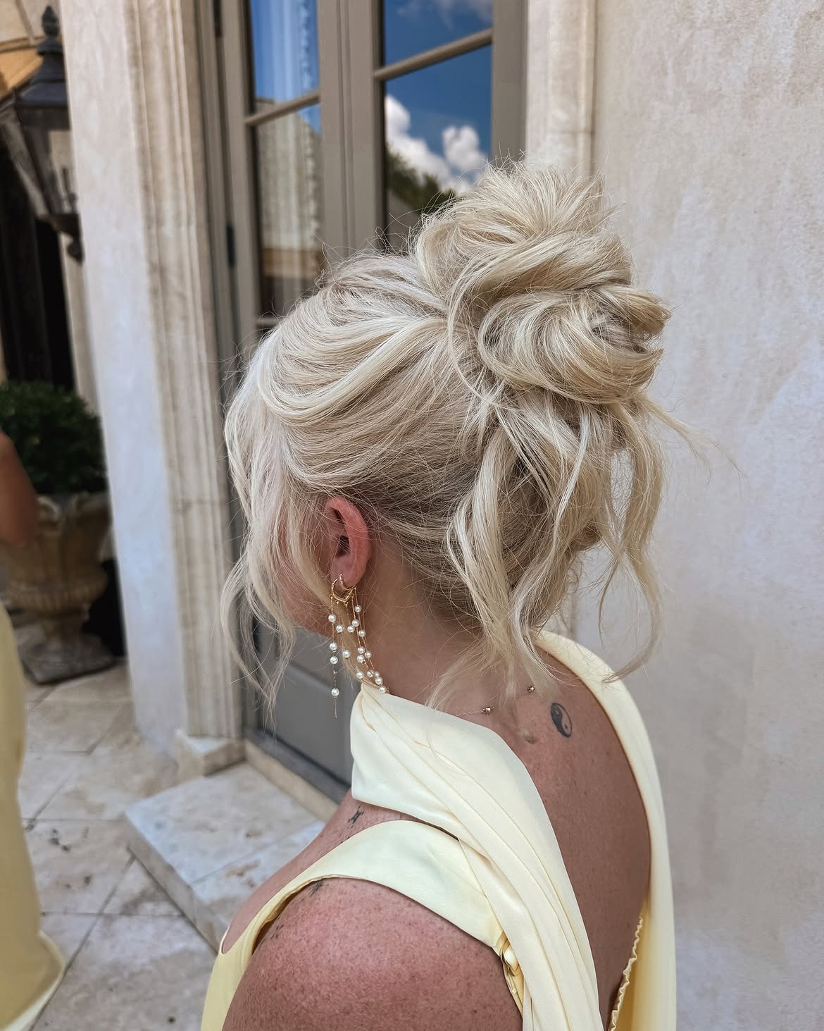 Effortless Messy Blonde Updo With Face-Framing Tendrils