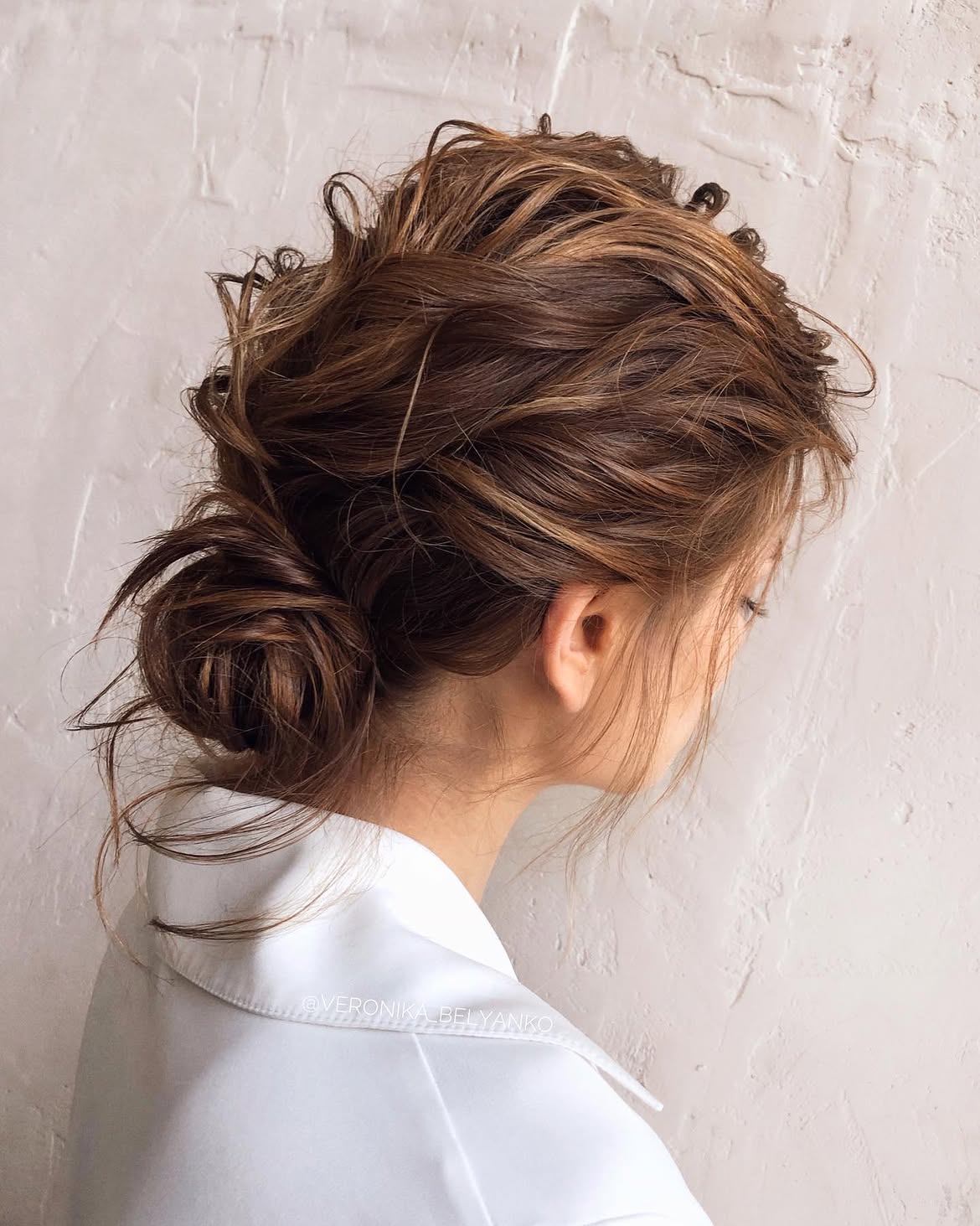 Effortless Tousled Low Bun With Wispy Strands