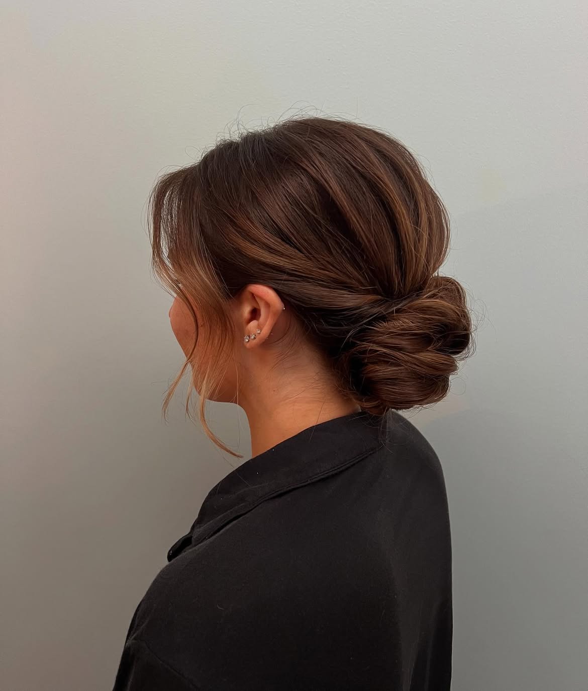 Effortless Woven Low Bun With Face-Framing Tendrils