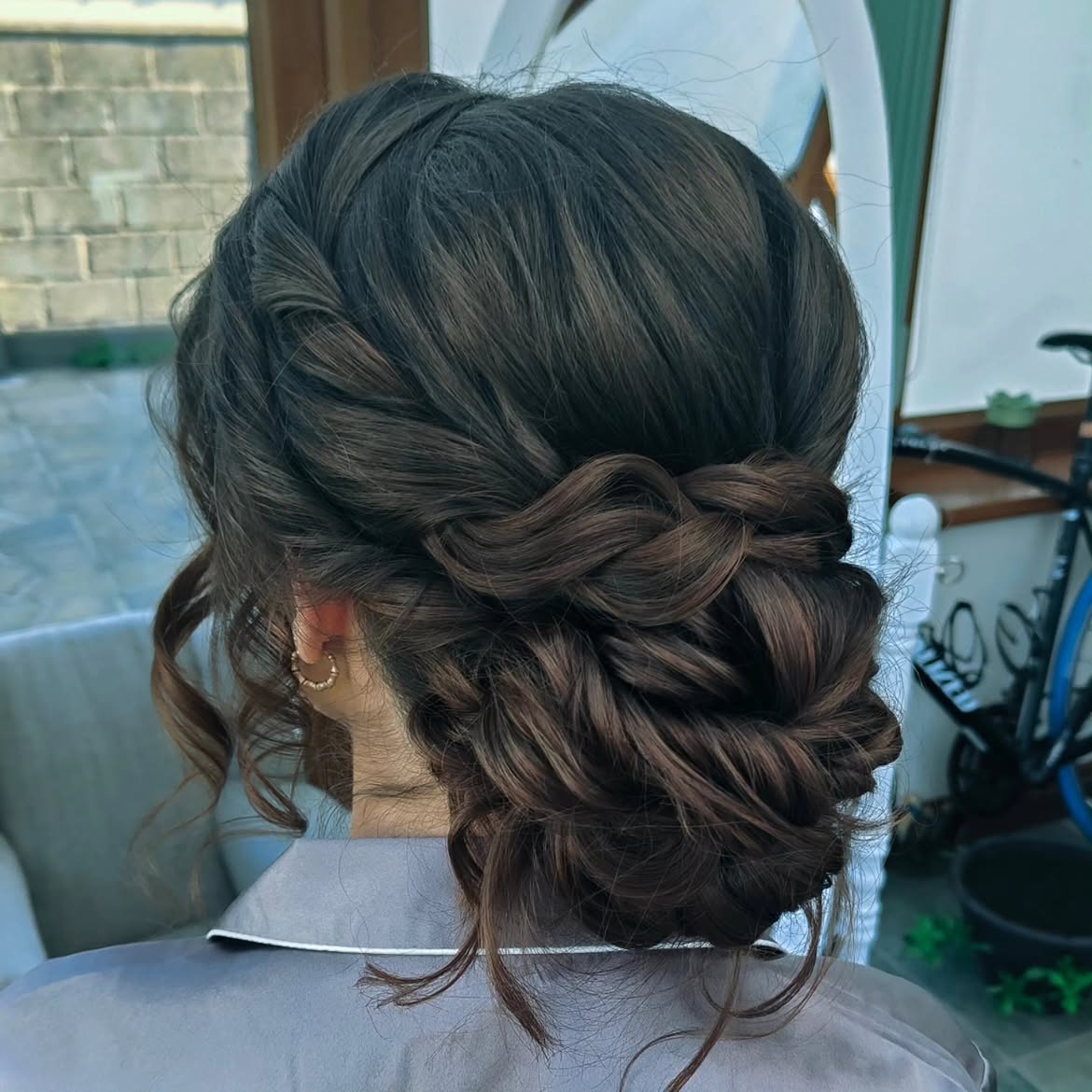 Elegant Braided Low Updo With Loose Tendrils