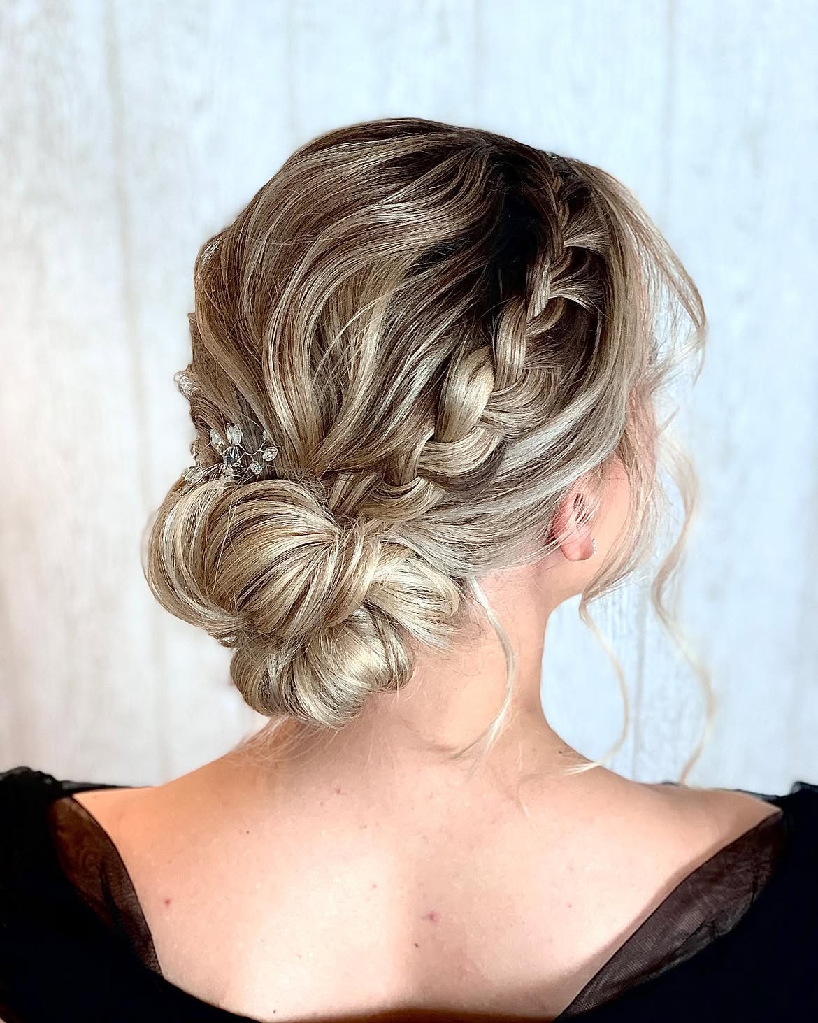 Elegant Braided Updo With Loose Tendrils