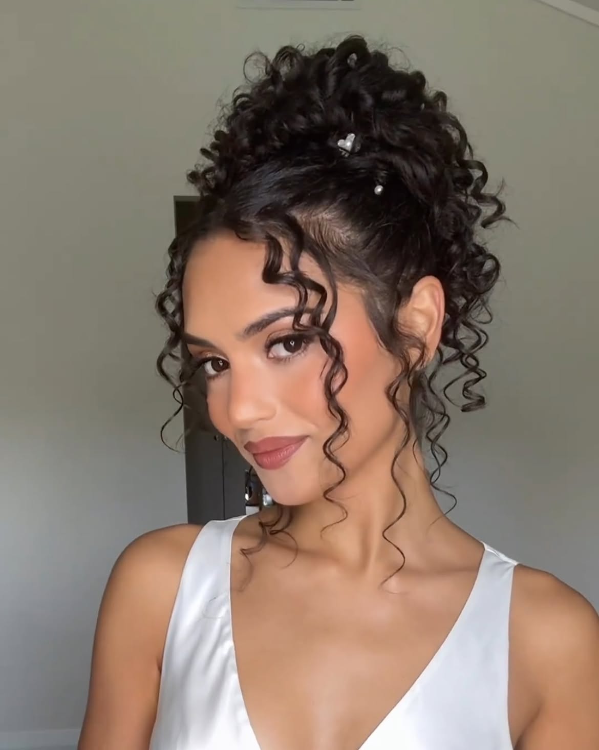 Elegant Curly Updo With Face-Framing Tendrils