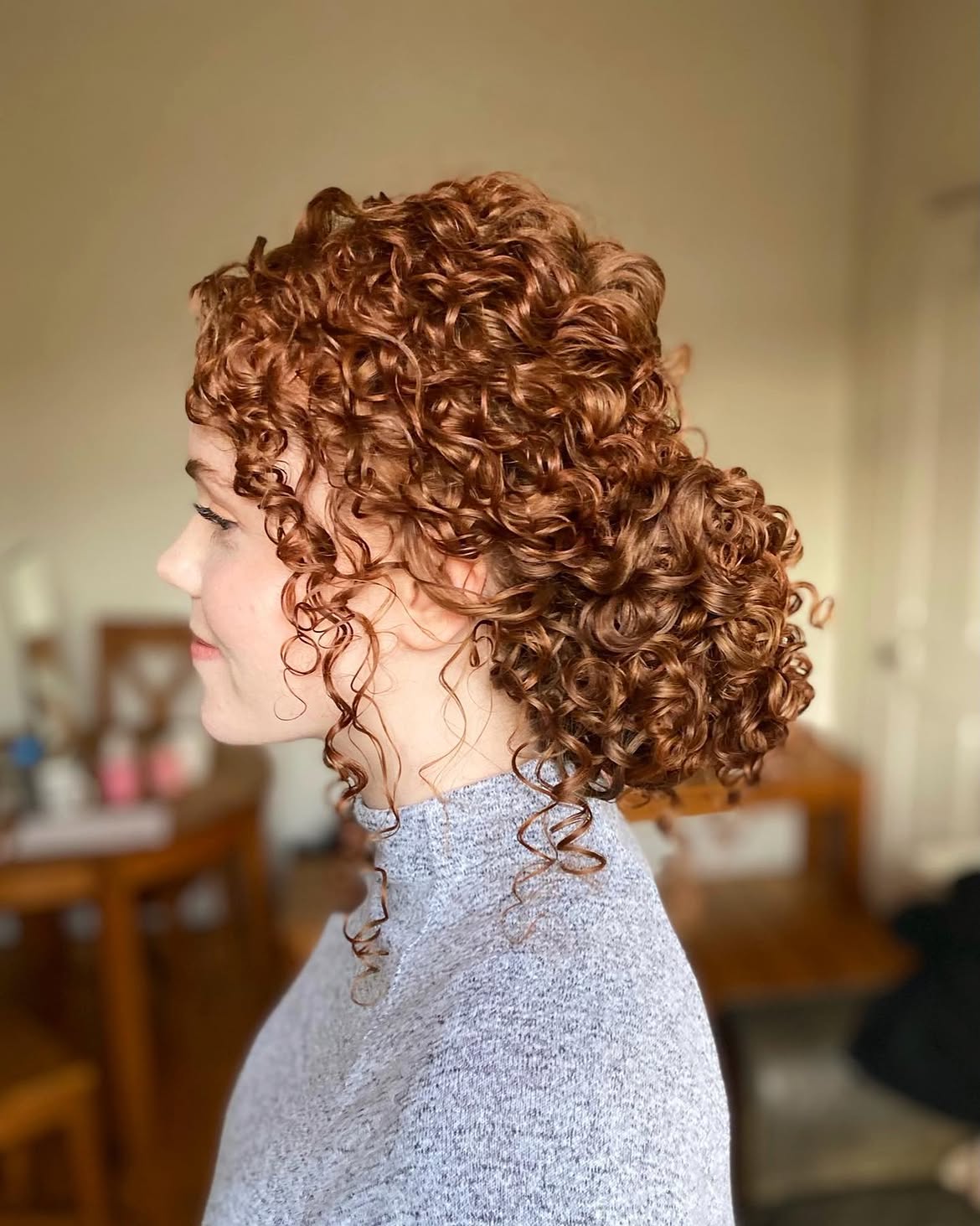 Elegant Curly Updo With Loose Tendrils