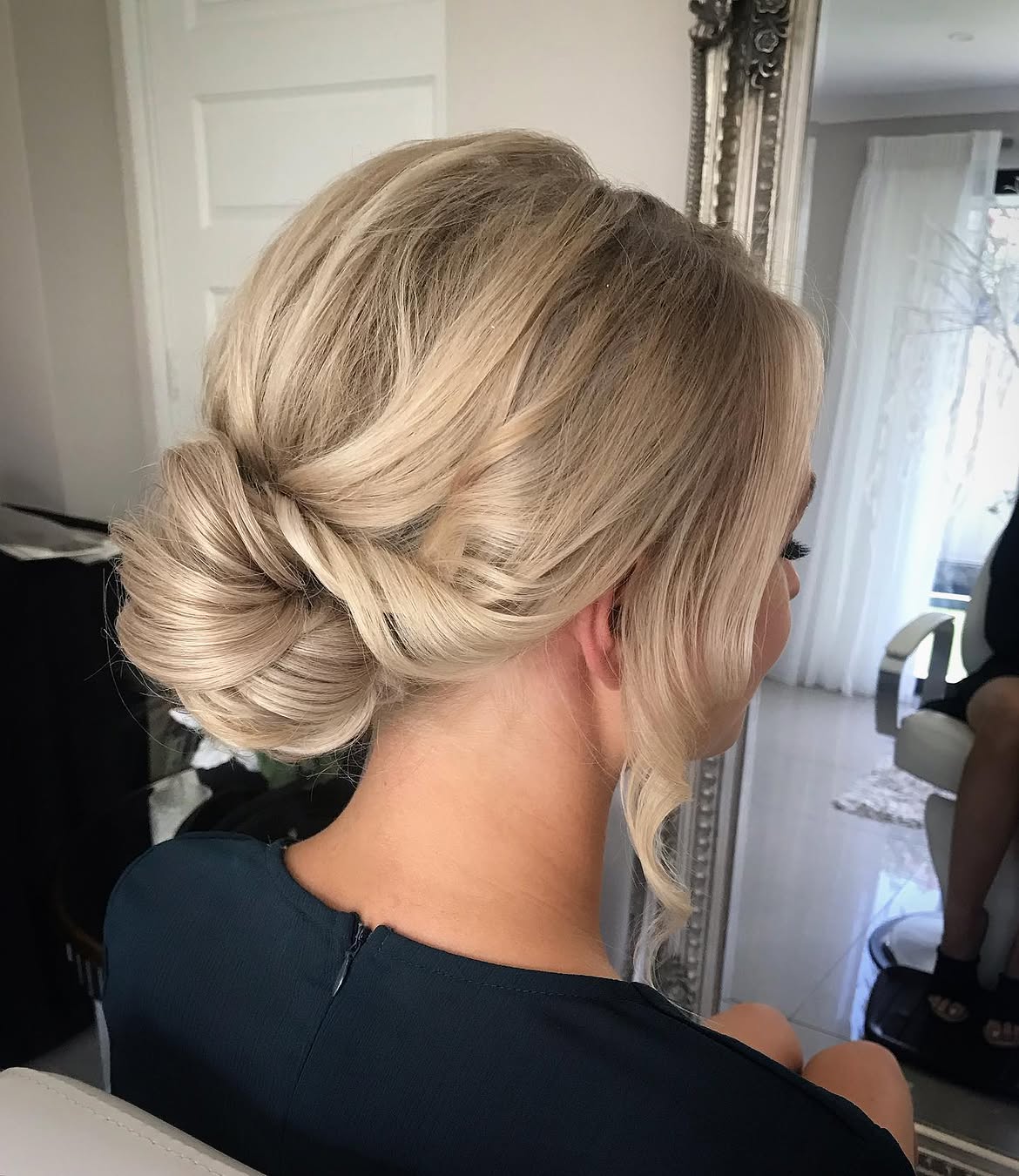 Elegant Twisted Low Bun With Blonde Balayage