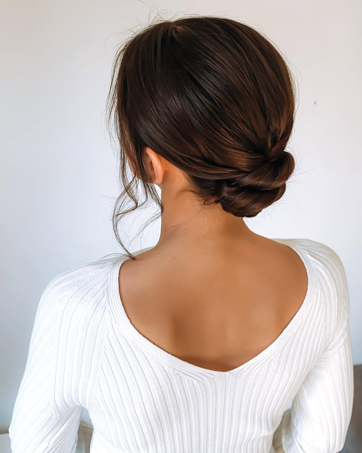 Elegant Twisted Low Bun With Face Framing Tendrils