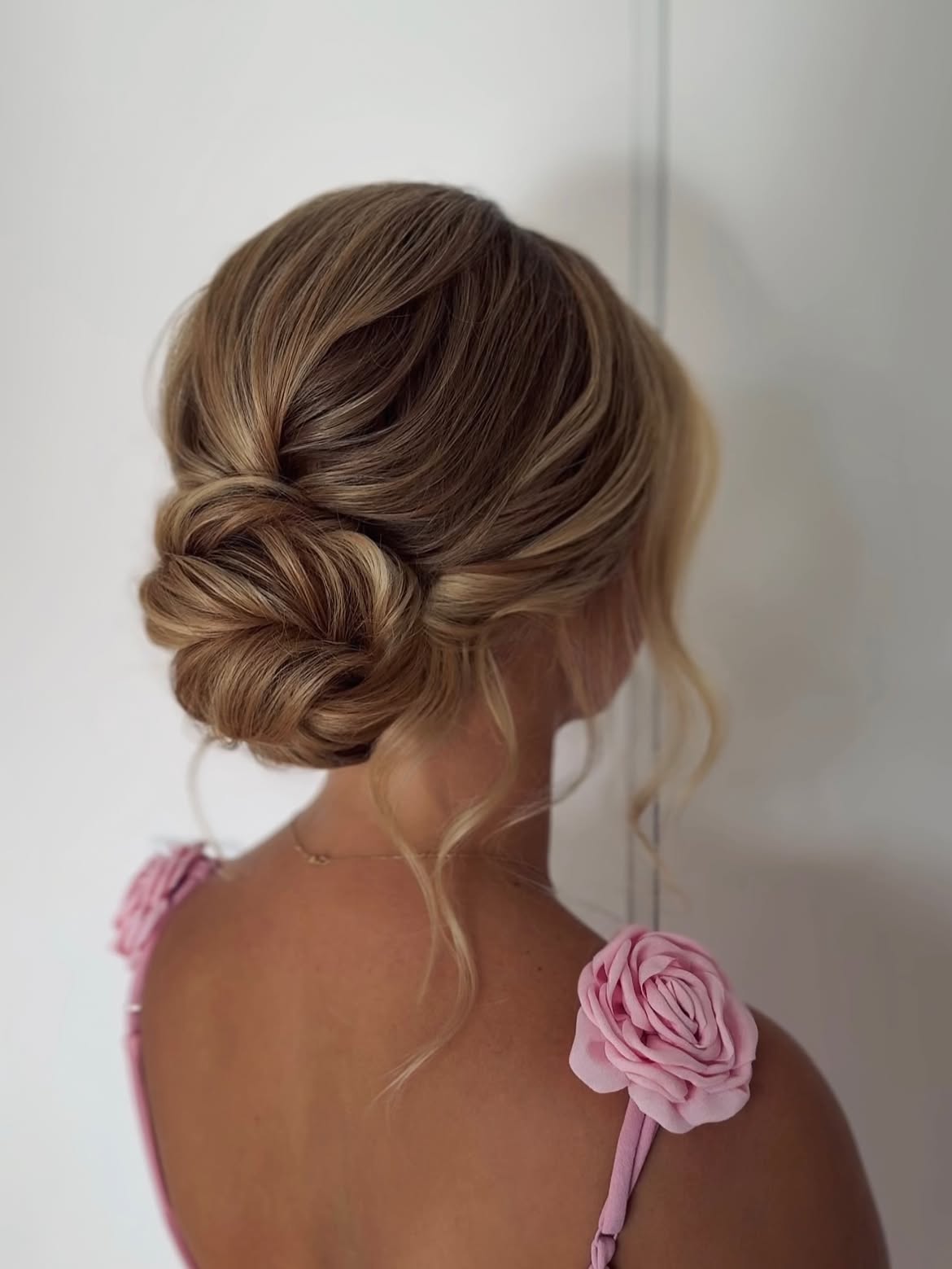 Elegant Twisted Low Updo With Loose Tendrils