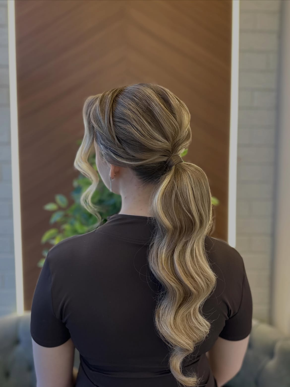 Elegant Wavy Low Ponytail With Face-Framing Tendrils