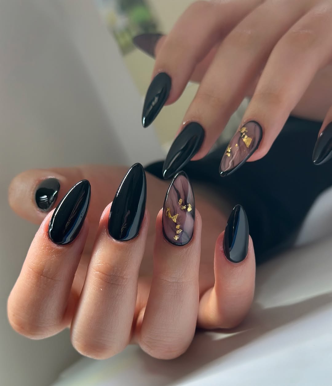 Glossy Black Almond Nails with Marble Art