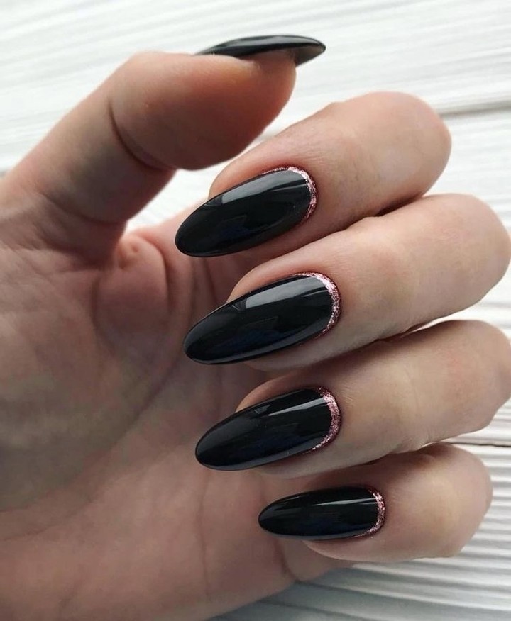 Glossy Black Almond Nails with Rose Gold Glitter French