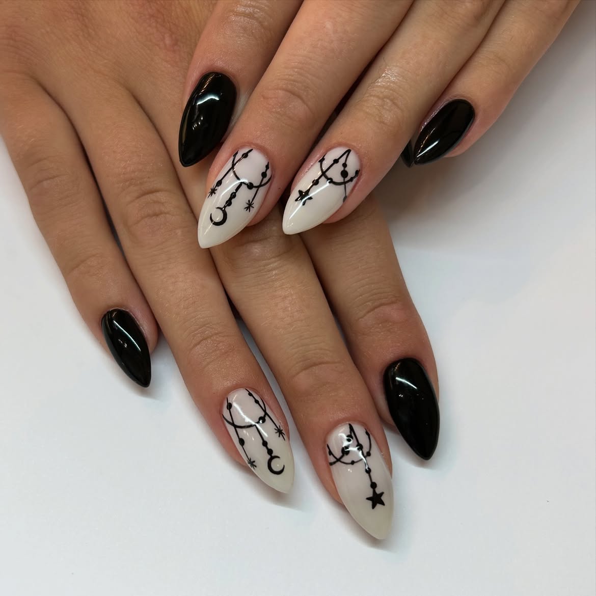 Glossy Black and Cream Celestial Almond Nails