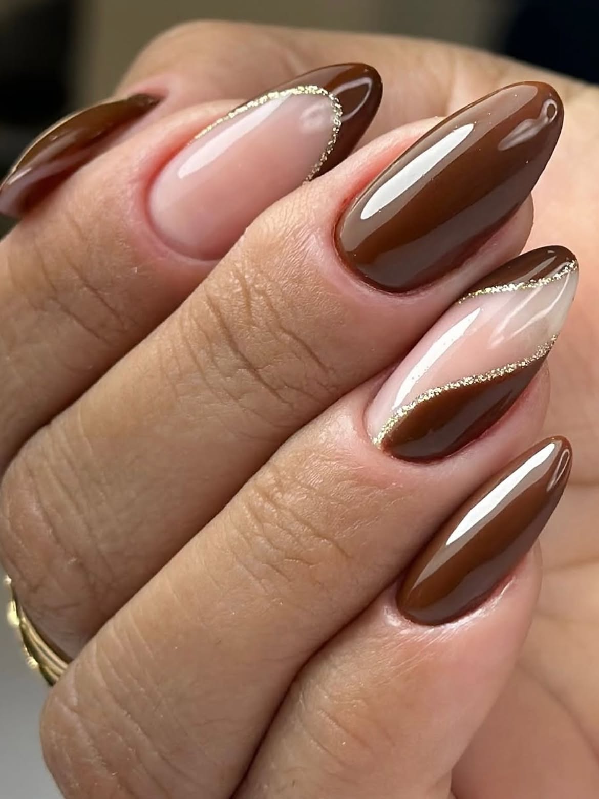 Glossy Chocolate Brown Almond Nails with Gold Glitter Line