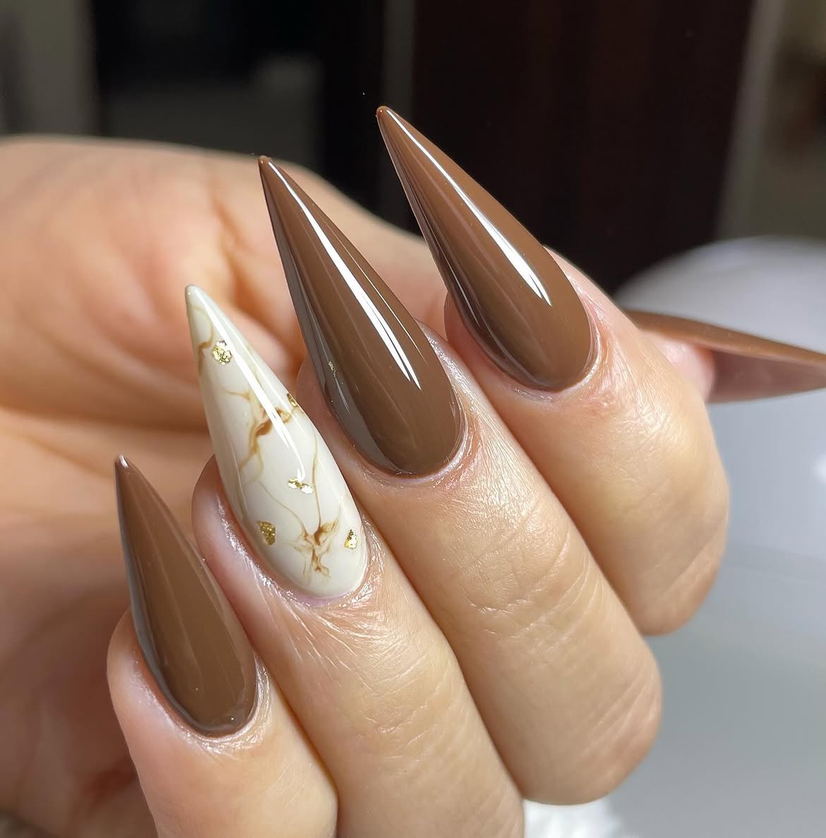 Glossy Chocolate Swirl Stiletto Nails with Gold Accents