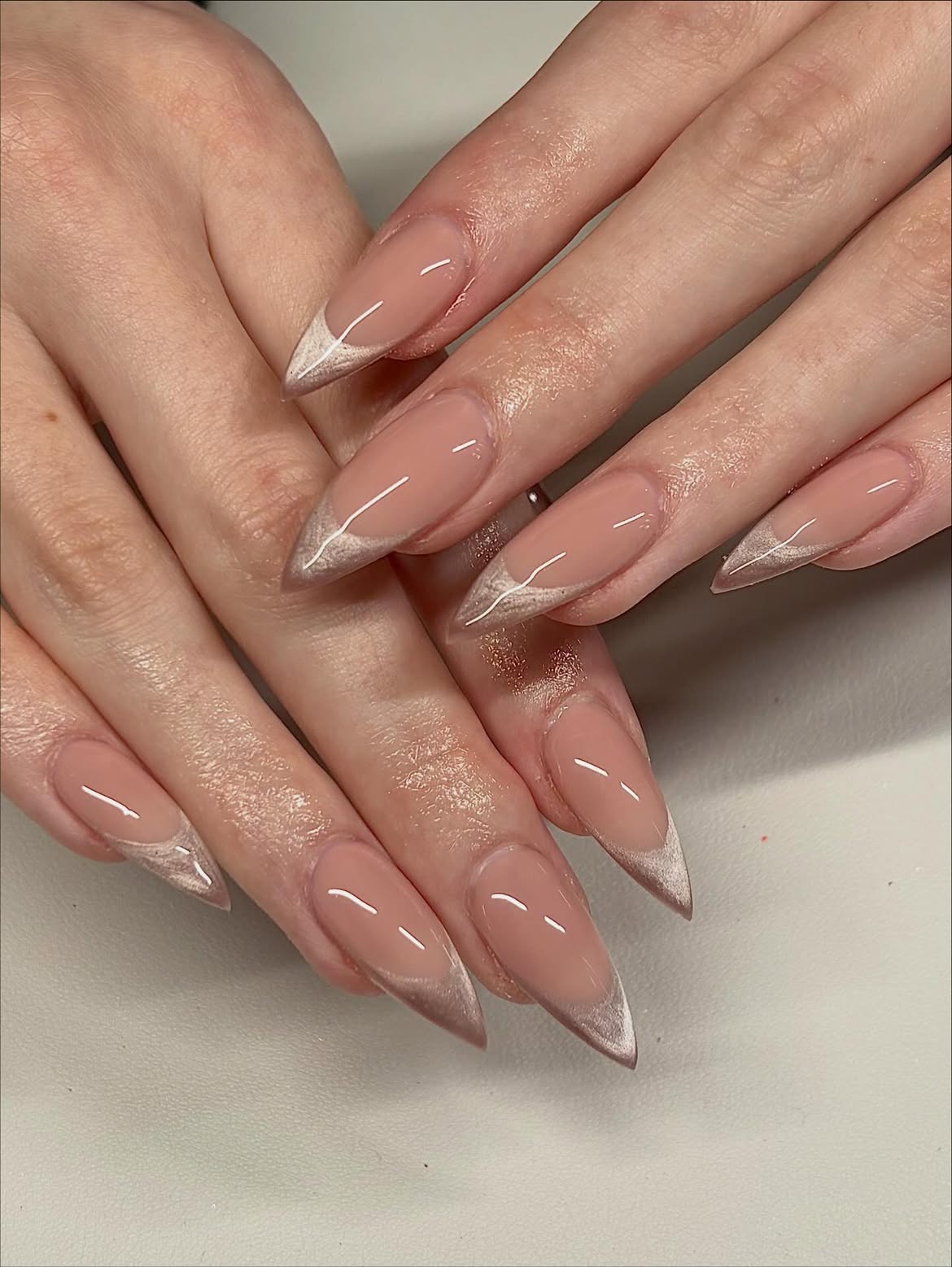 Glossy Nude Stiletto French with Champagne Chrome Tips