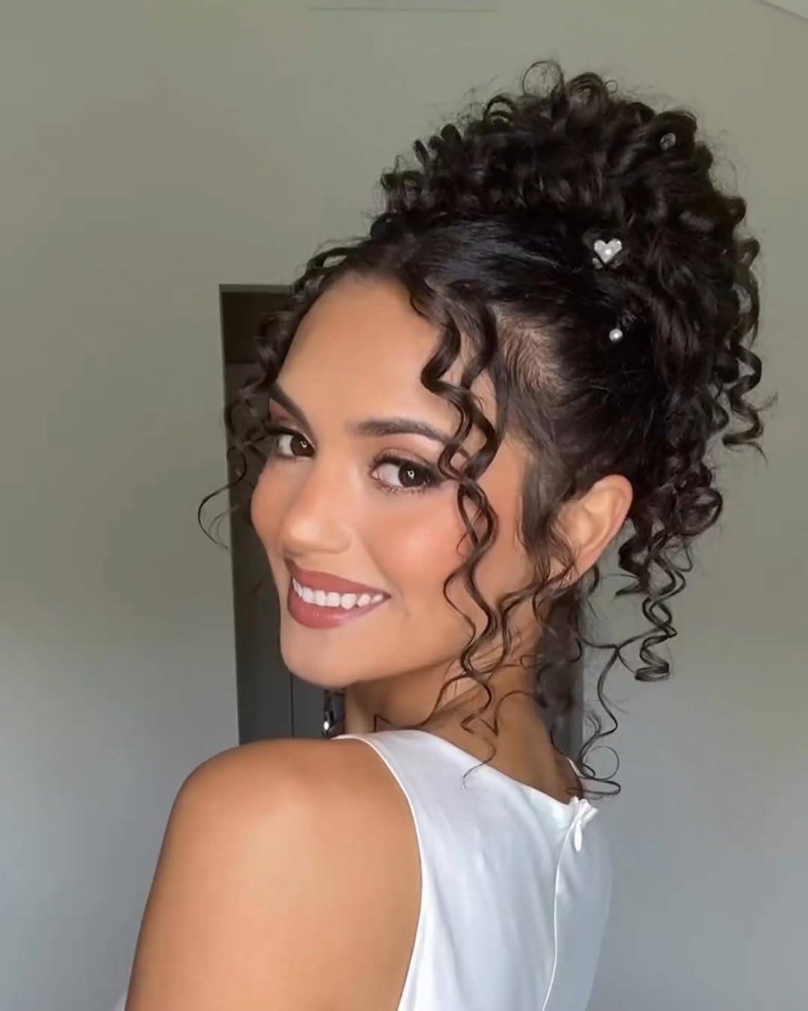 High Curly Ponytail With Face Framing Tendrils