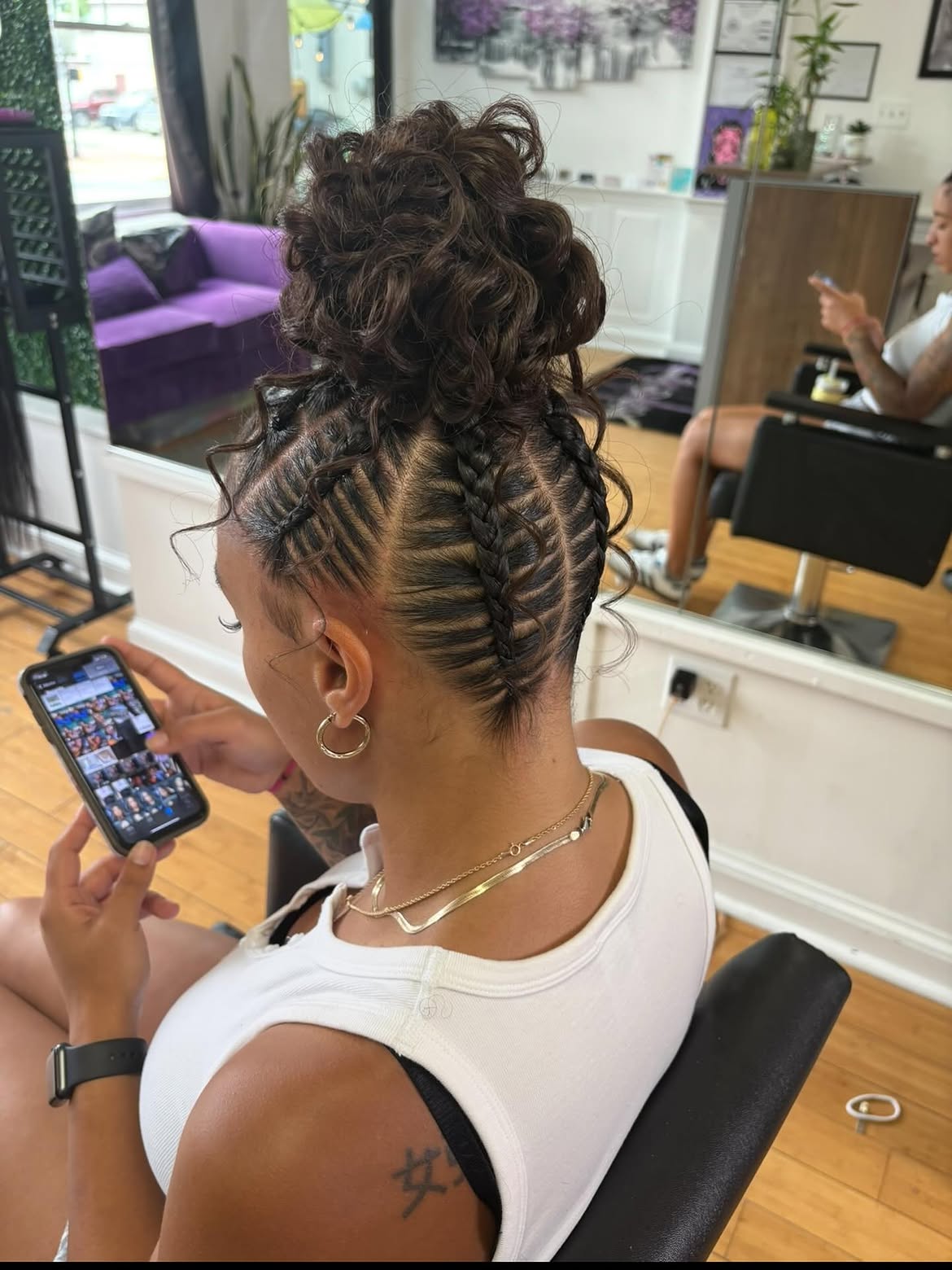 Intricate Cornrow Braids With A Messy Top Bun