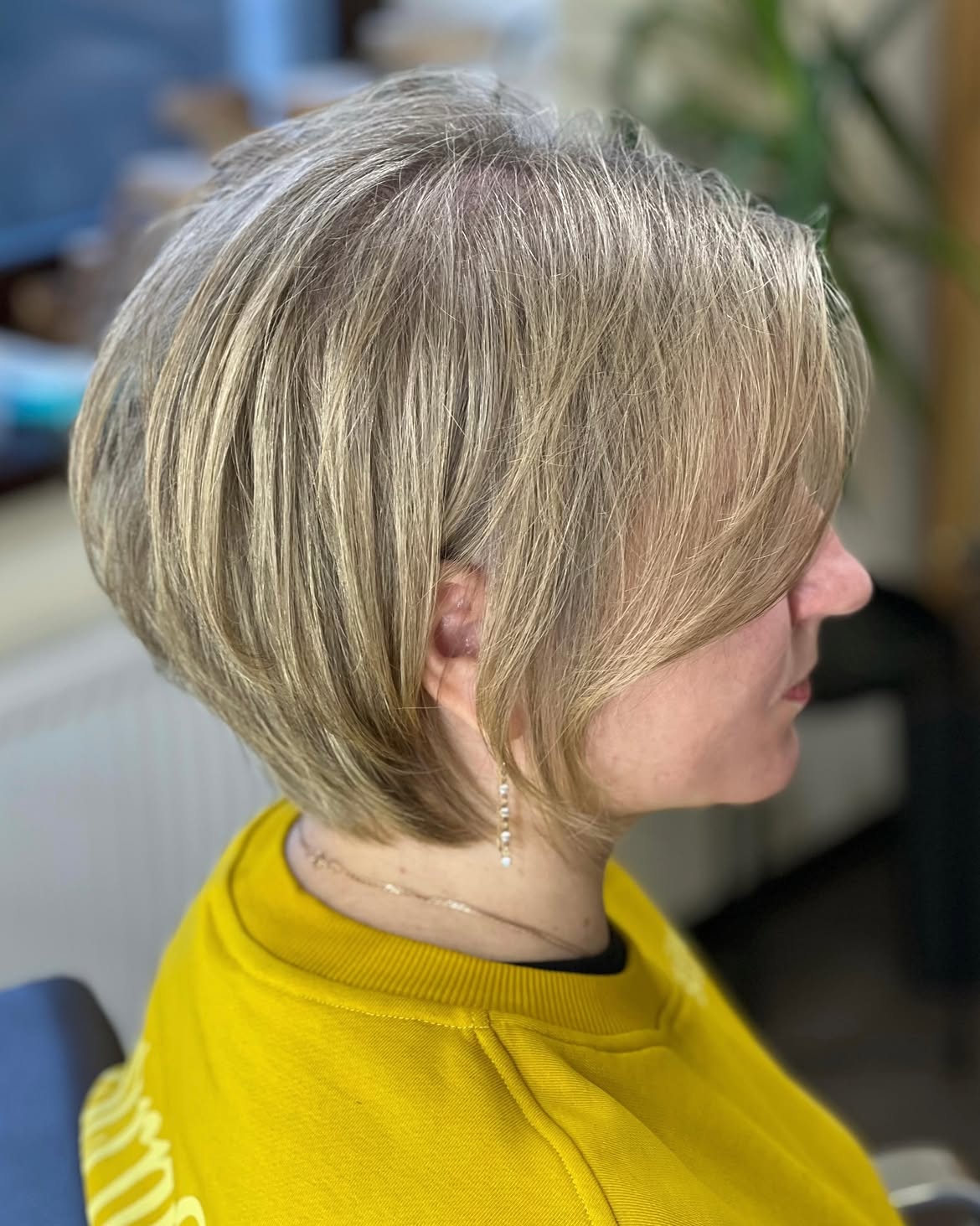 Layered Ash Blonde Pixie Bob With Side Swept Fringe