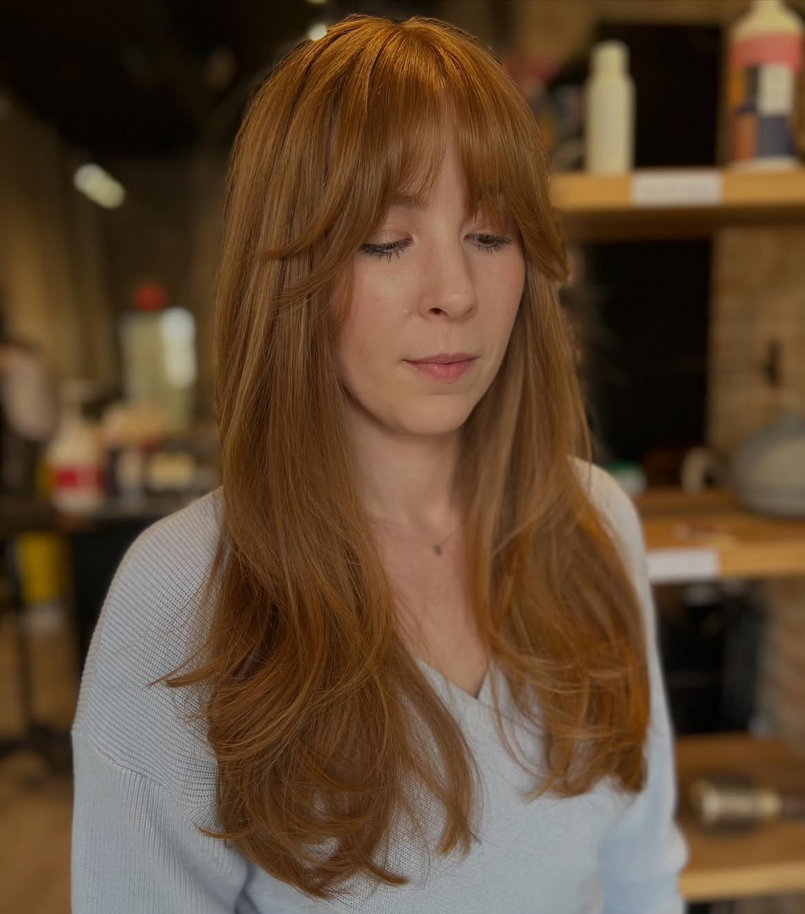 Long Layers With Soft Copper Curtain Bangs