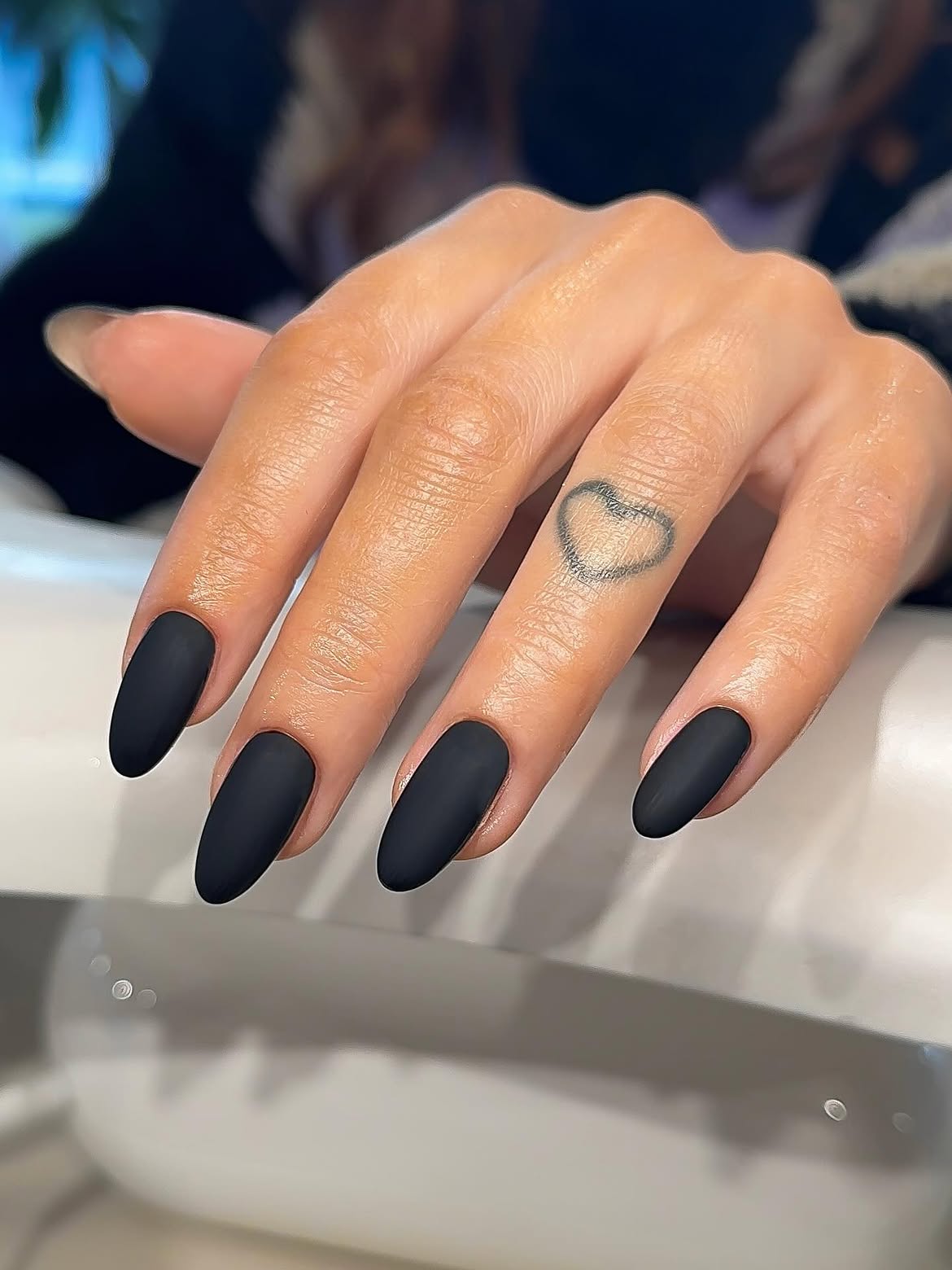 Matte Black Almond Nails With Heart Tattoo