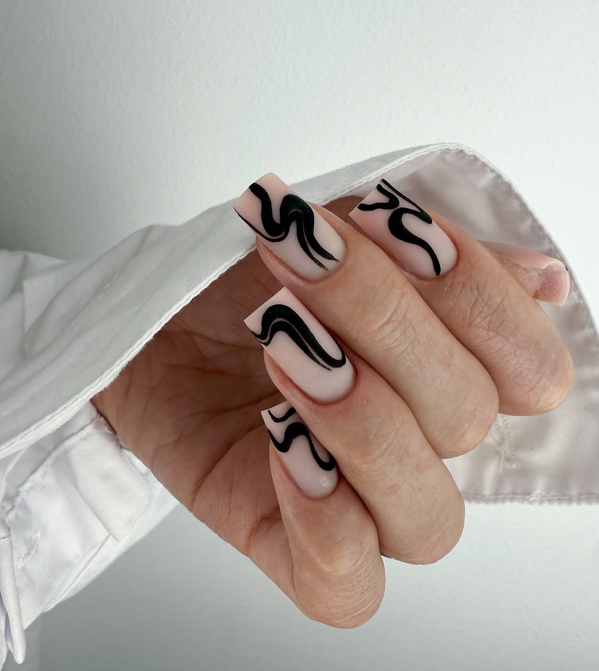 Matte Nude Nails with Black Swirl Art