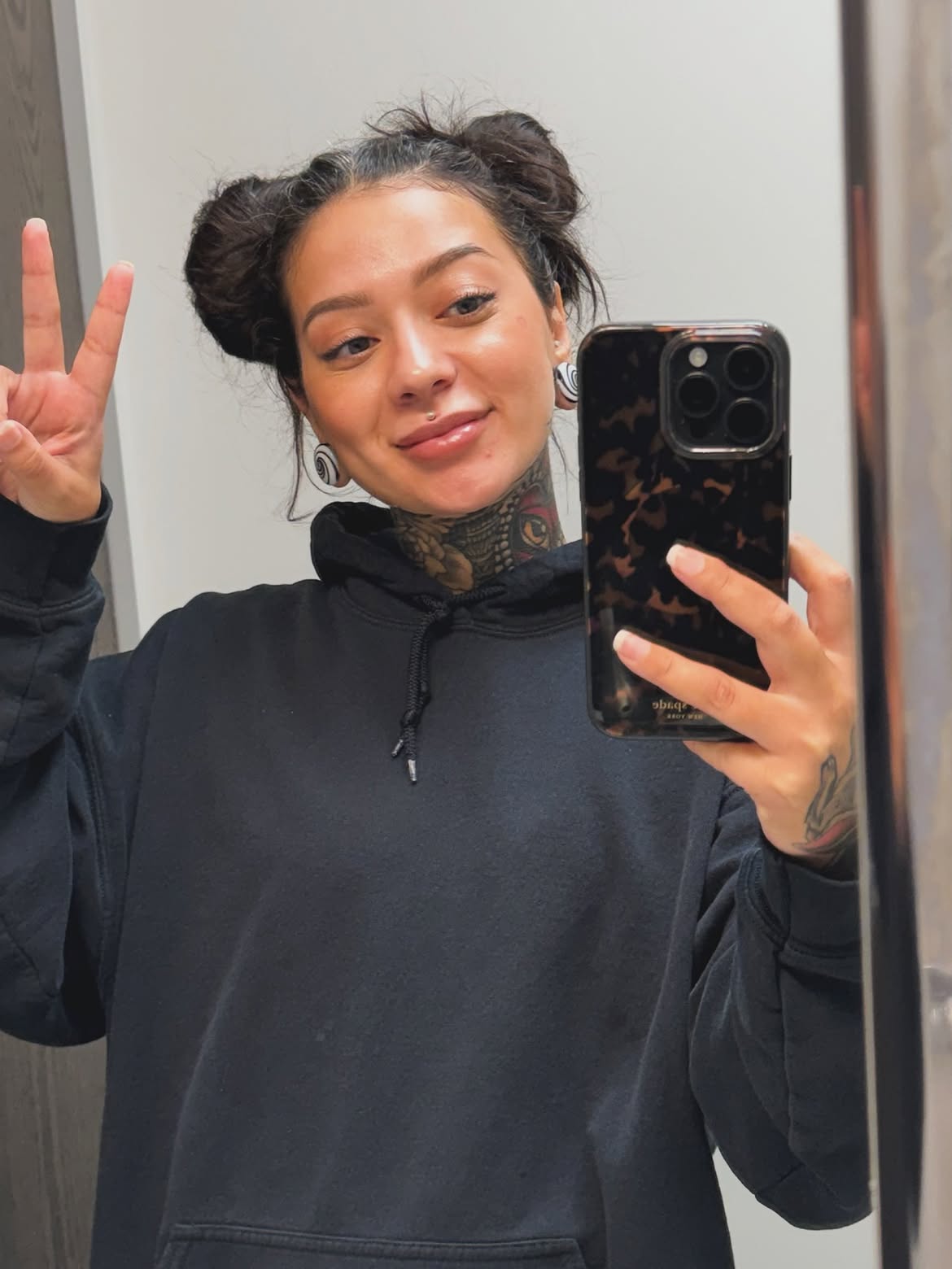 Messy High Space Buns With Wispy Face Framing
