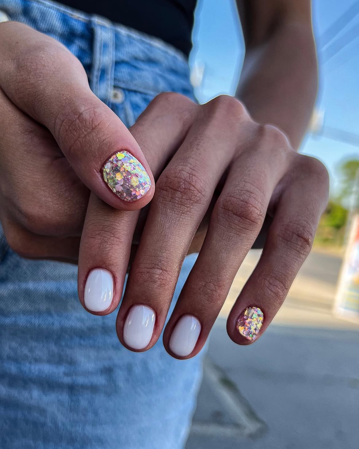 Milky White Nails with Iridescent Glitter Accents