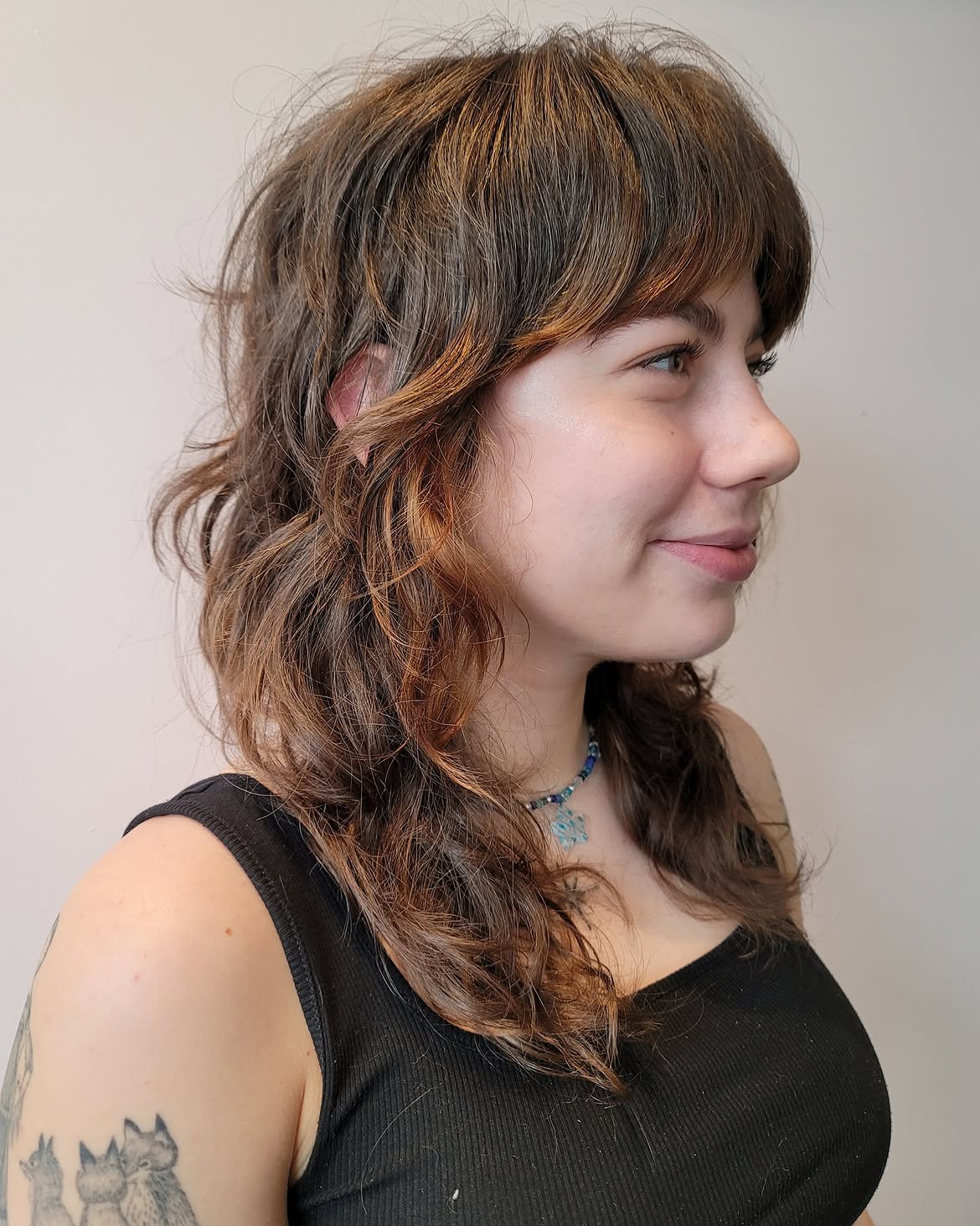 Modern Shag With Copper Highlights And Wispy Bangs