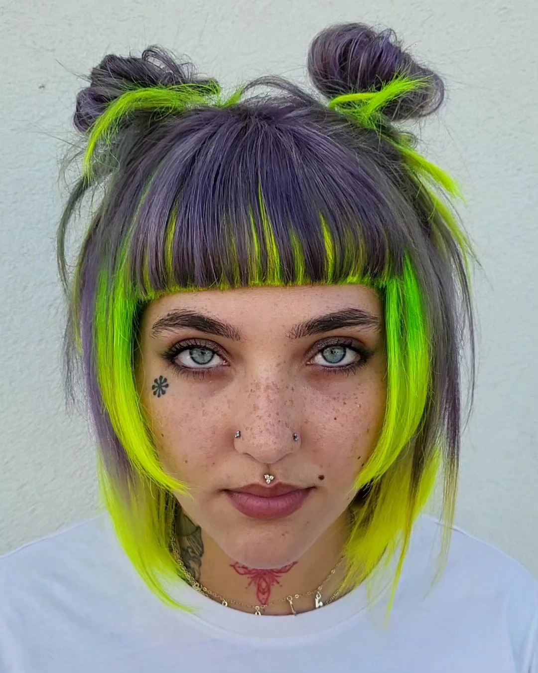 Neon Green And Purple Space Buns With Blunt Bangs