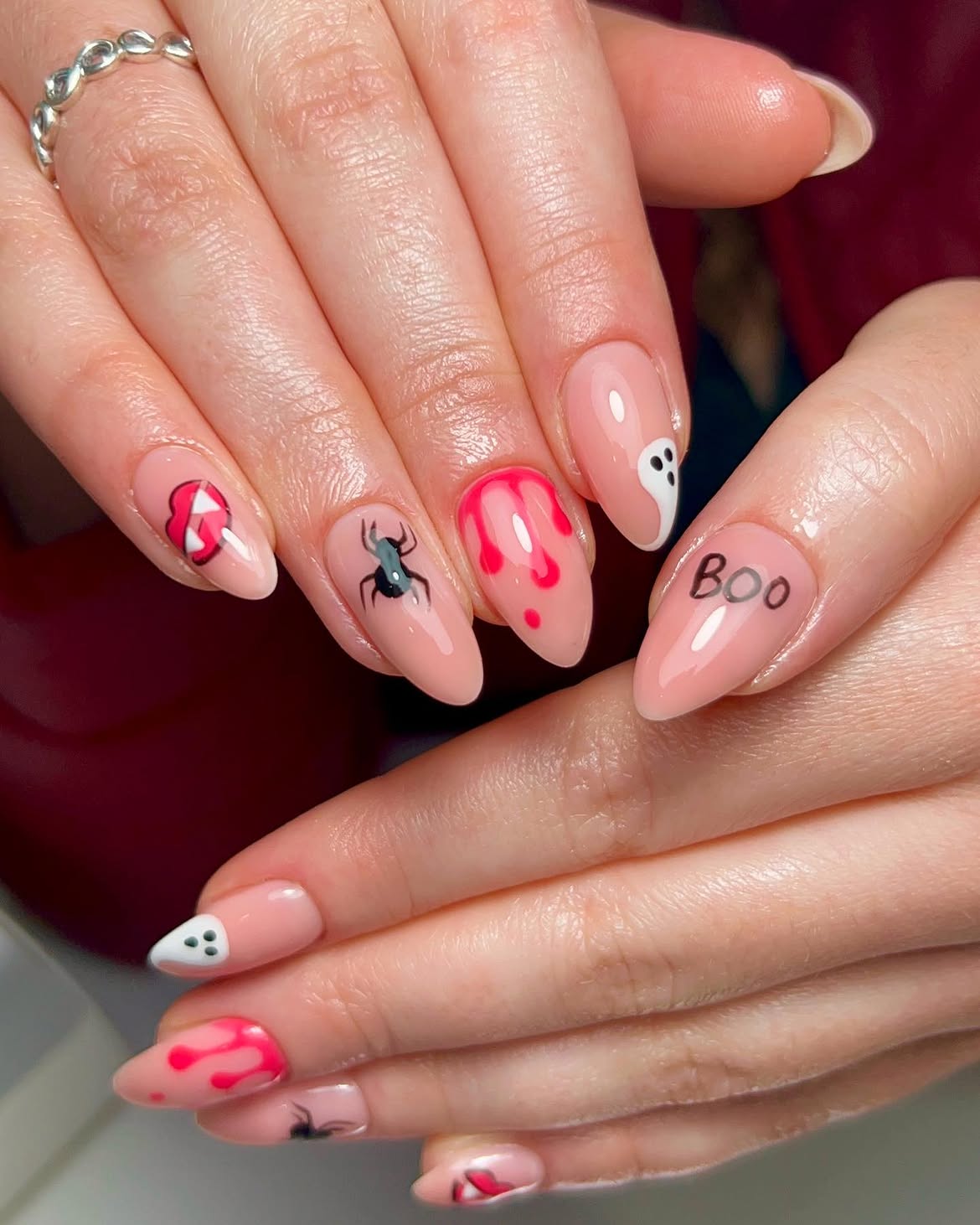 Playful Pink Halloween Nail Art with Ghosts and Spiders