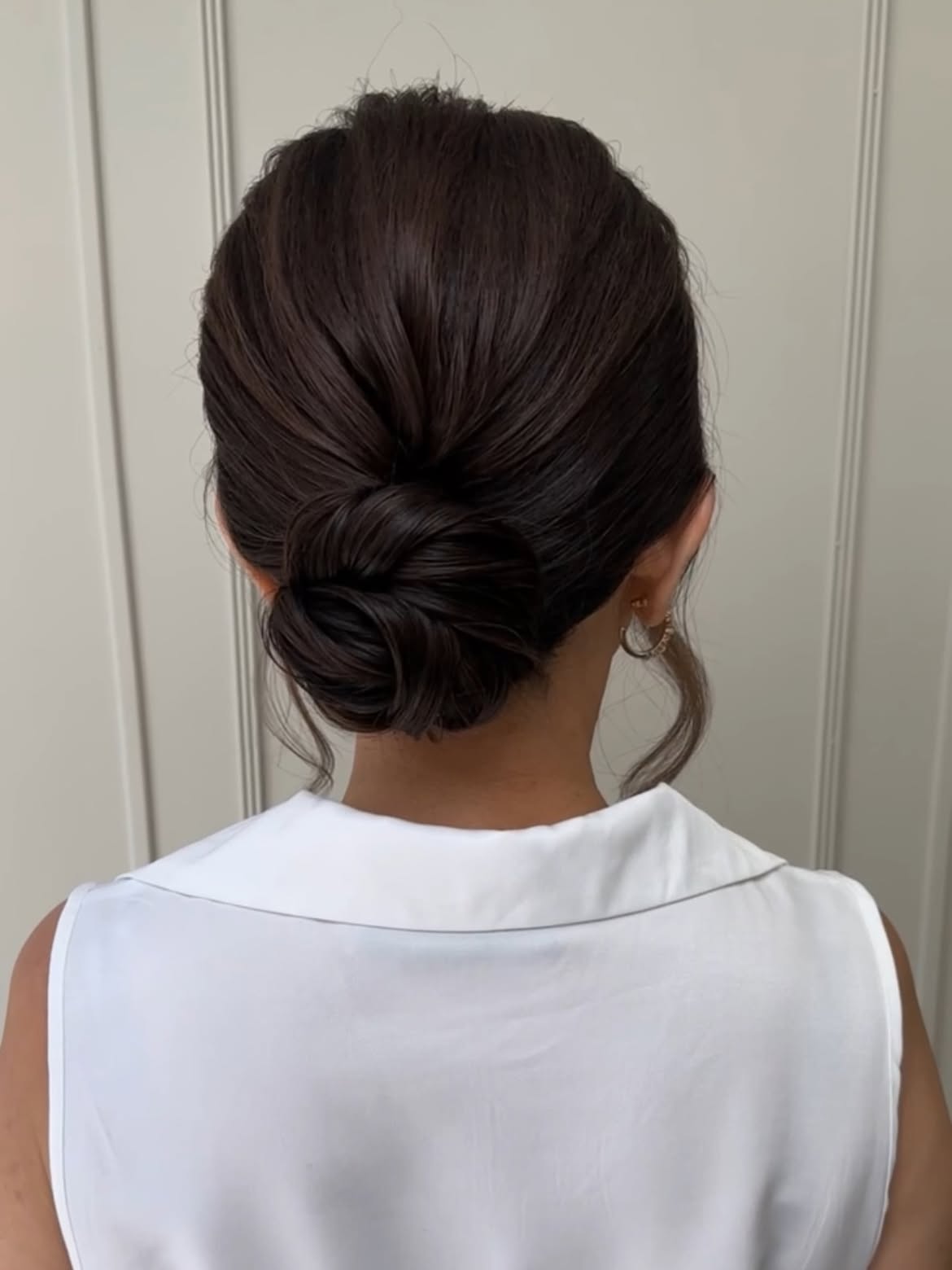 Polished Espresso Low Bun With Face Framing Tendrils